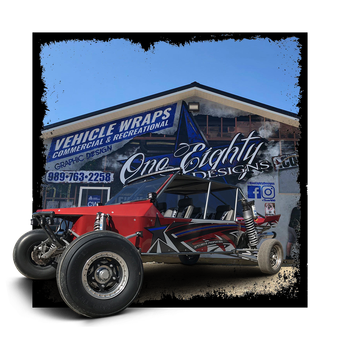 A red buggy is parked in front of a building.