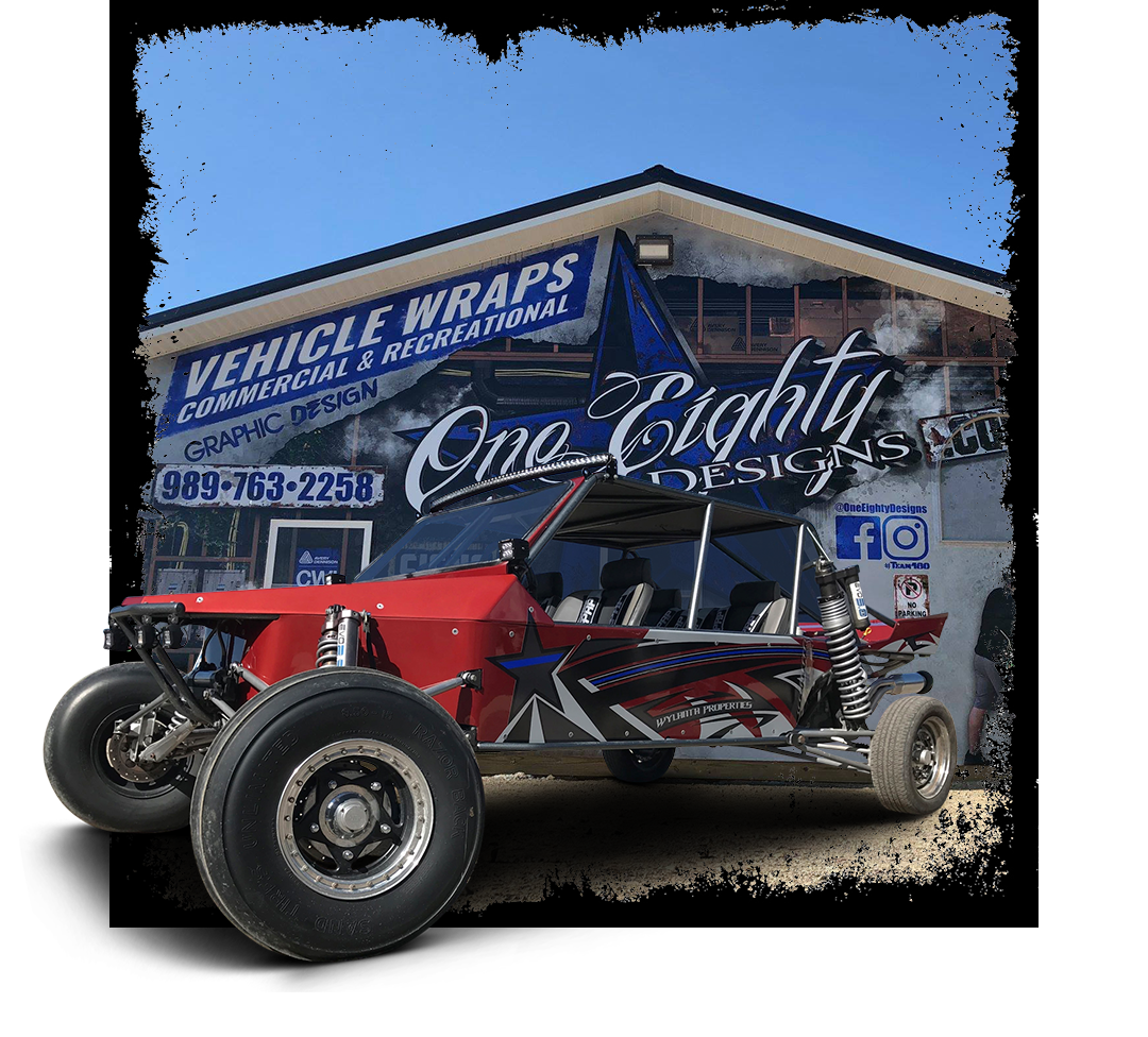 A red buggy is parked in front of a building that says vehicle wraps.