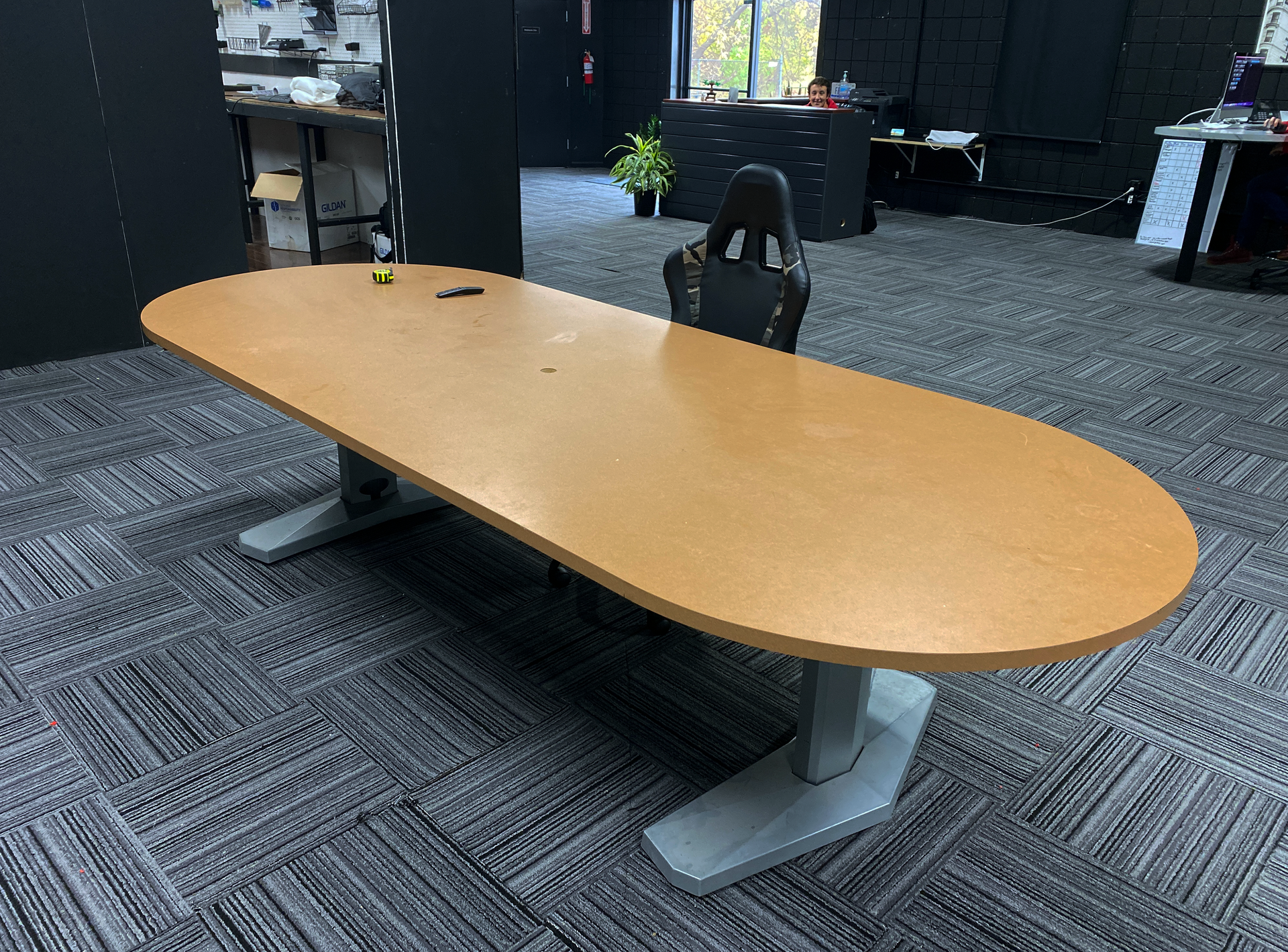 There is a long wooden table in the middle of the room.