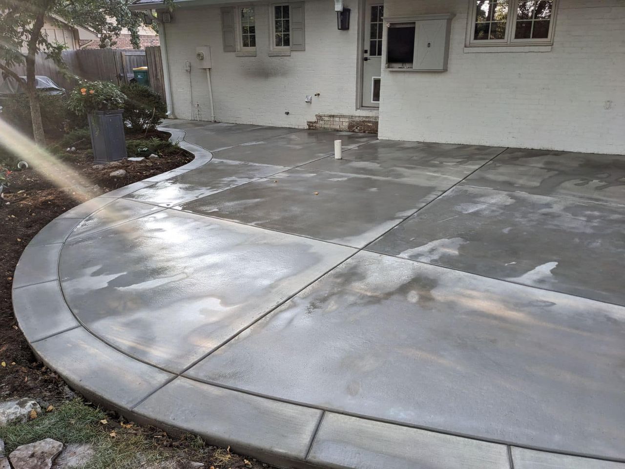 A concrete walkway is being built in front of a house.