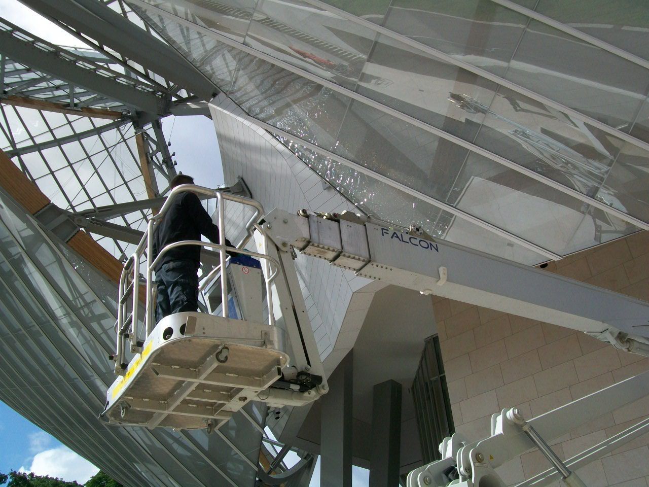 A large building under construction with a spider on the floor.