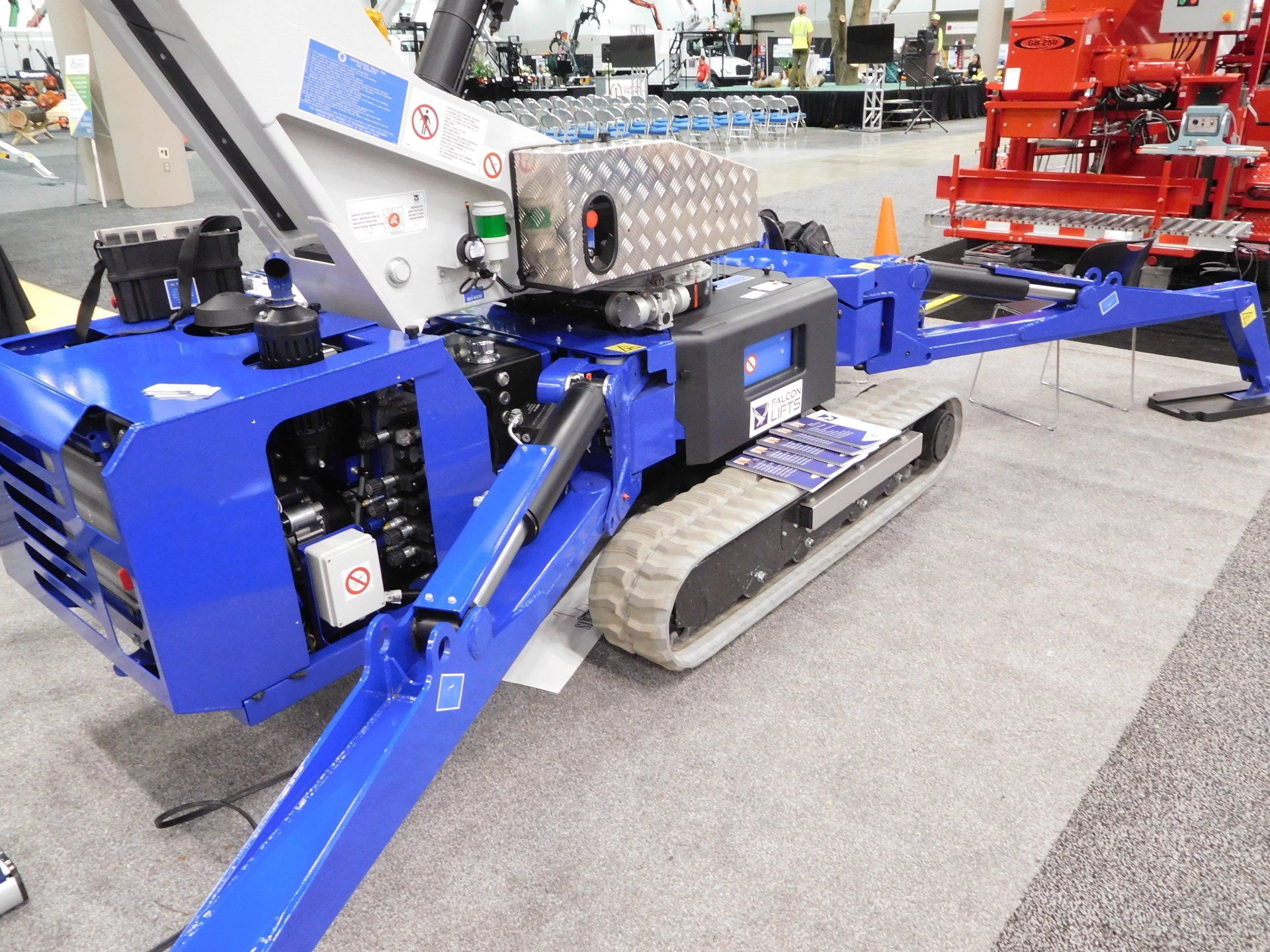A blue and white machine is sitting on a carpeted floor.