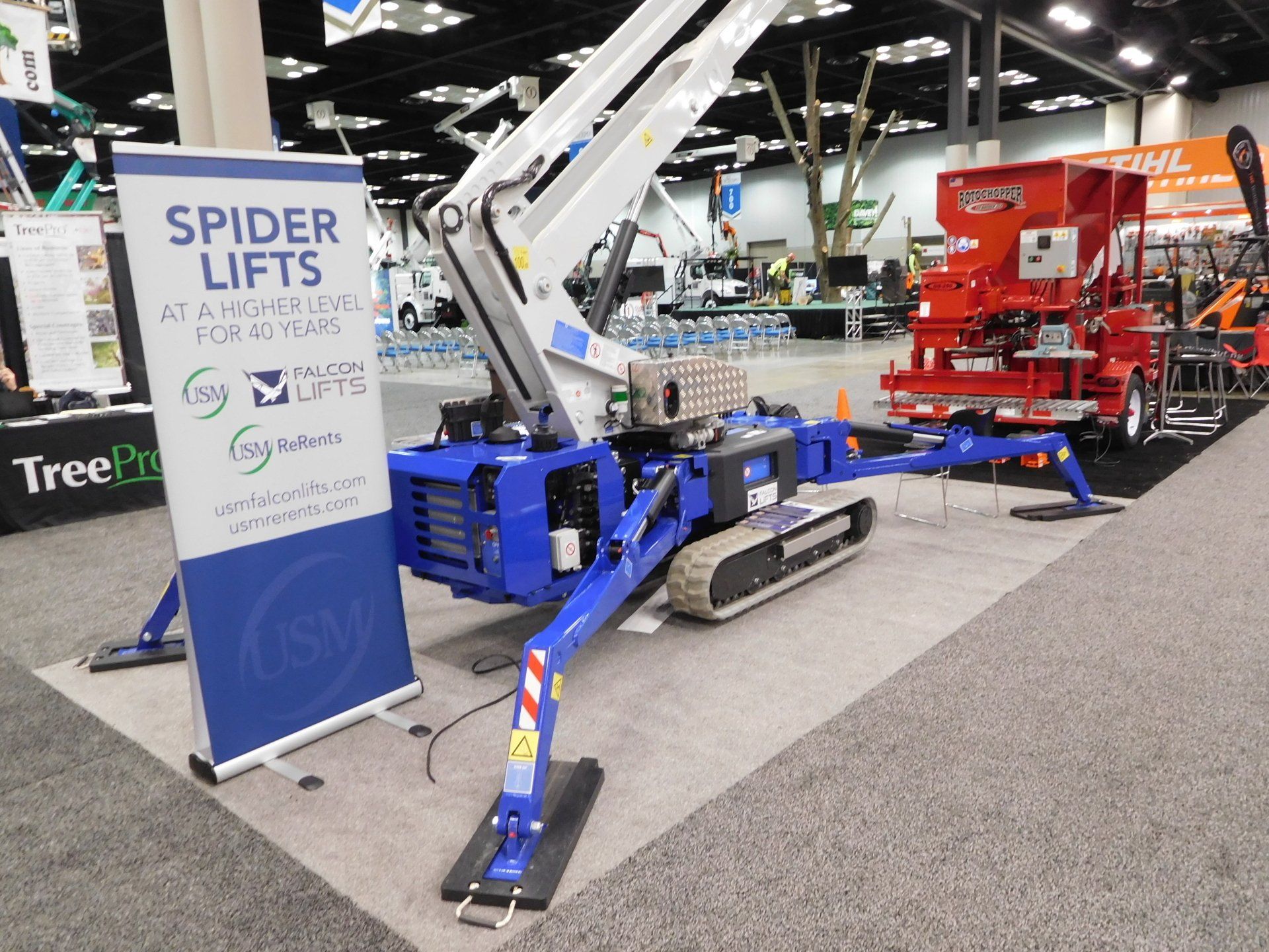 A spider lift is on display at a convention