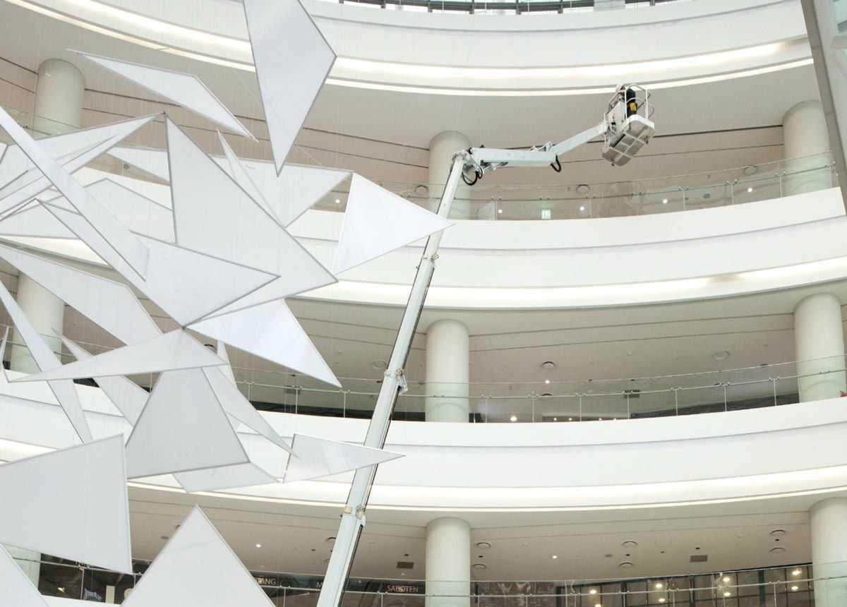 A large building under construction with a spider on the floor.