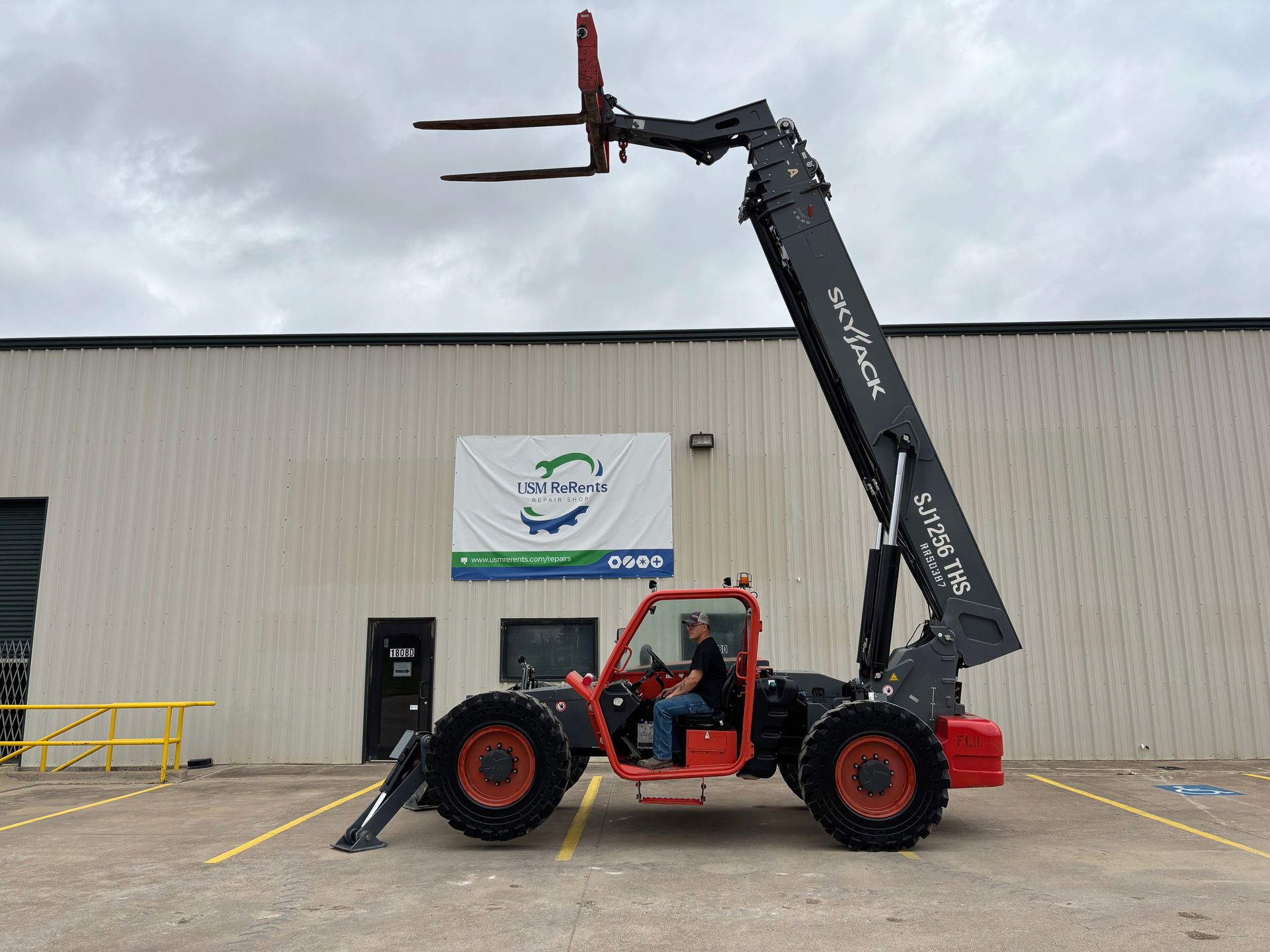 SKYJACK SJ1256TH Telehandler behind a building