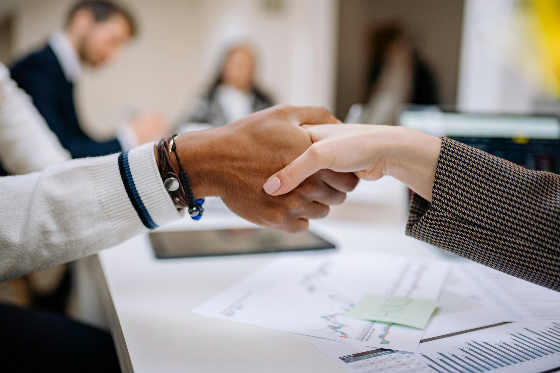 Two hands shaking, symbolizing partnership, collaboration, and mutual agreement