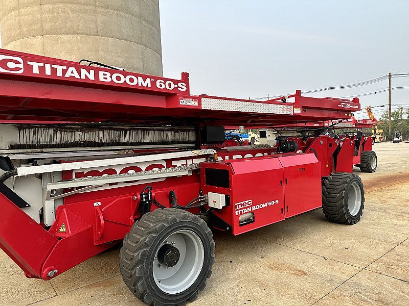 A red aerial lift is being used to work on a building