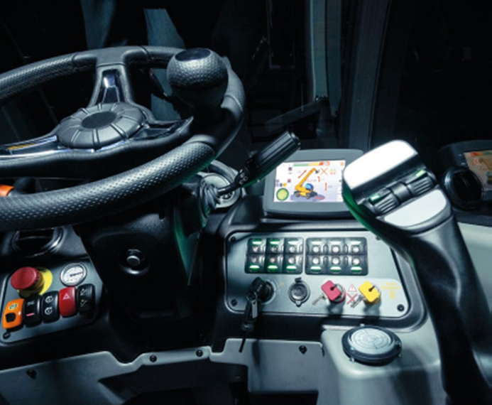 A close up of a steering wheel and control panel of a vehicle