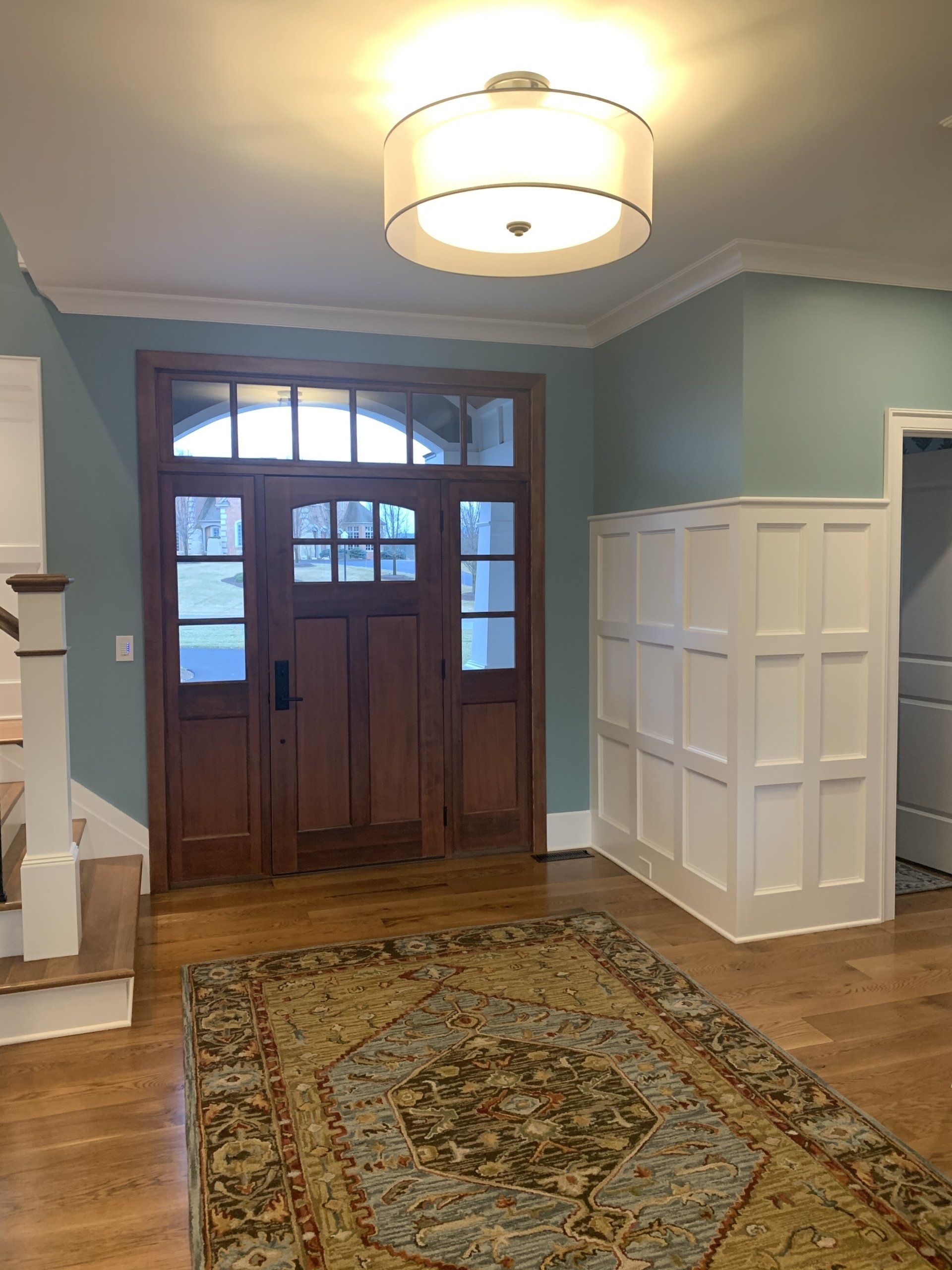 There is a rug in the middle of the room in front of the door.