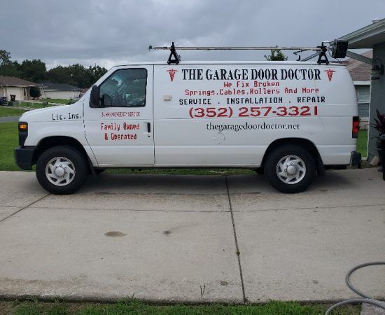 A white van that says the garage door doctor on it