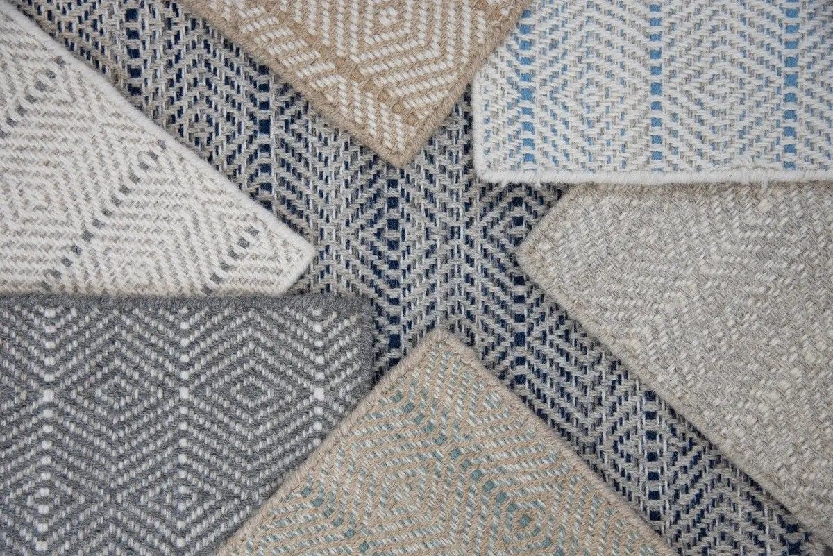 Six textured fabric swatches in neutral tones arranged in a geometric pattern.