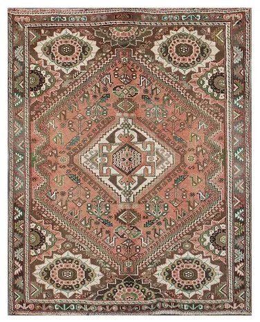 Vintage red and beige patterned rug with a central diamond medallion and ornate floral borders