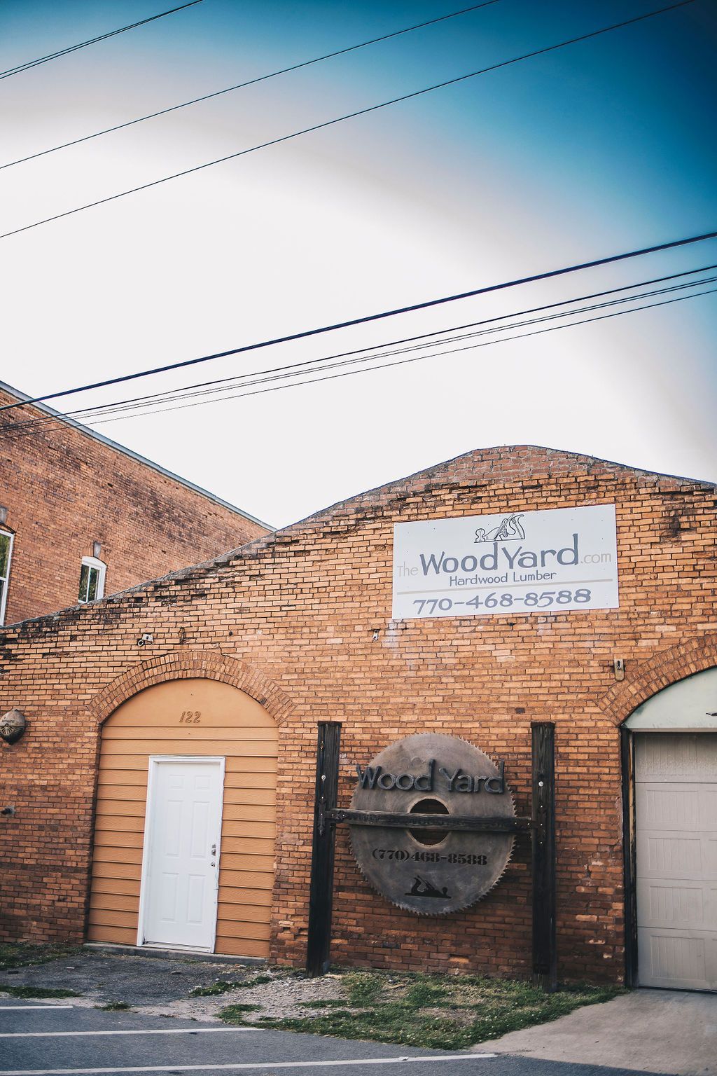 A brick building with a white door and a sign on it.