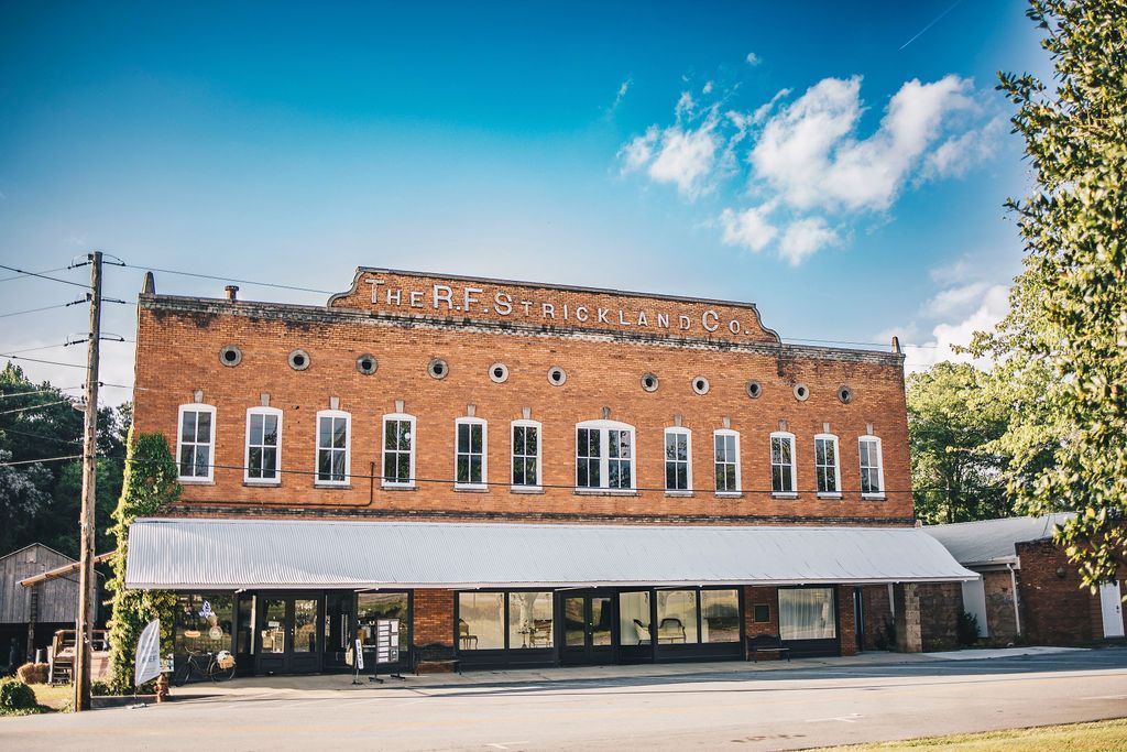 A large brick building with a white awning on a sunny day.