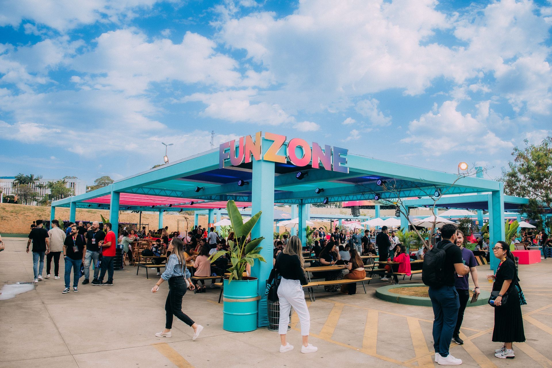 A group of people are standing in front of a building that says fun zone.