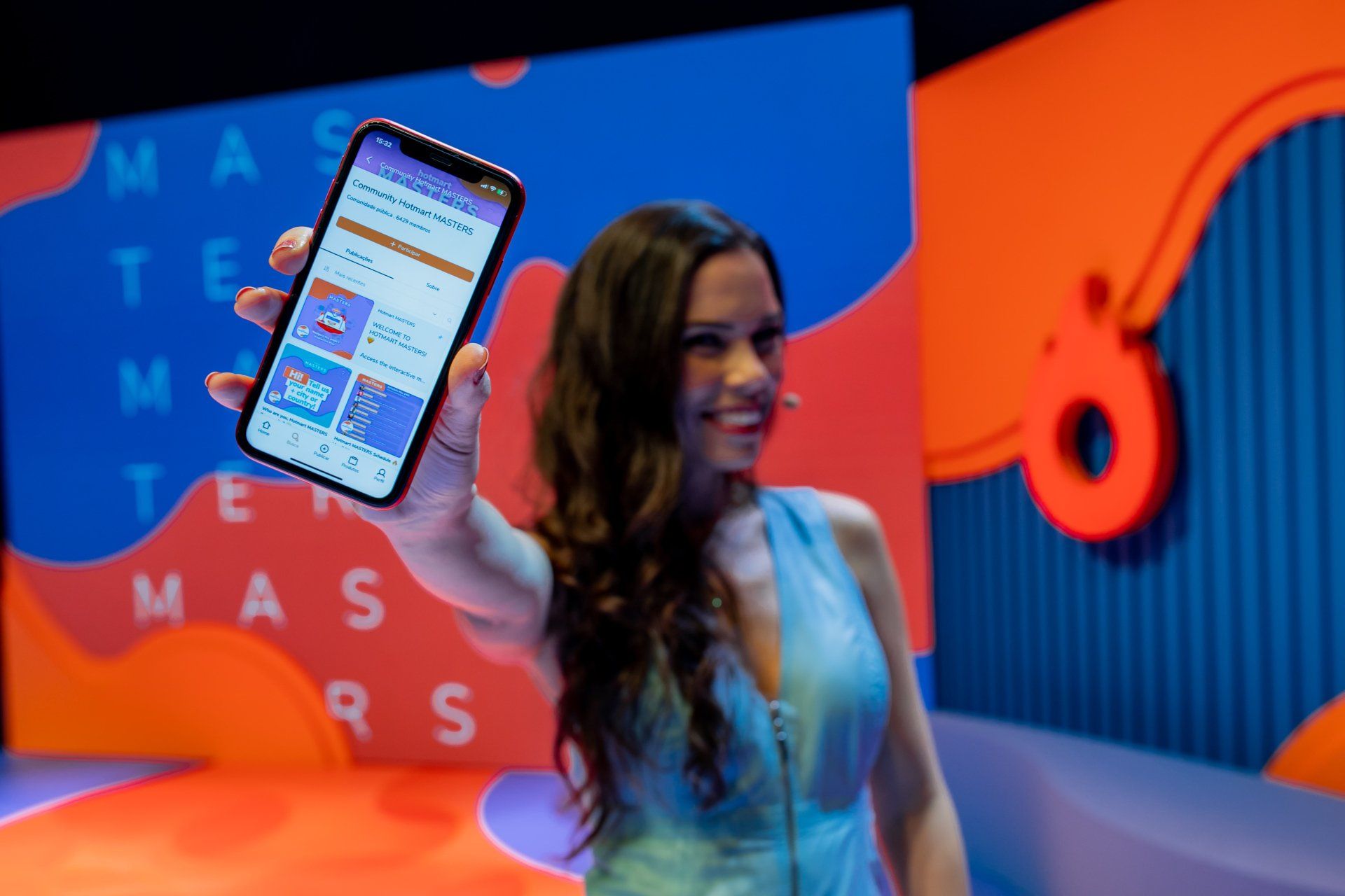 A woman is holding a cell phone in her hand.