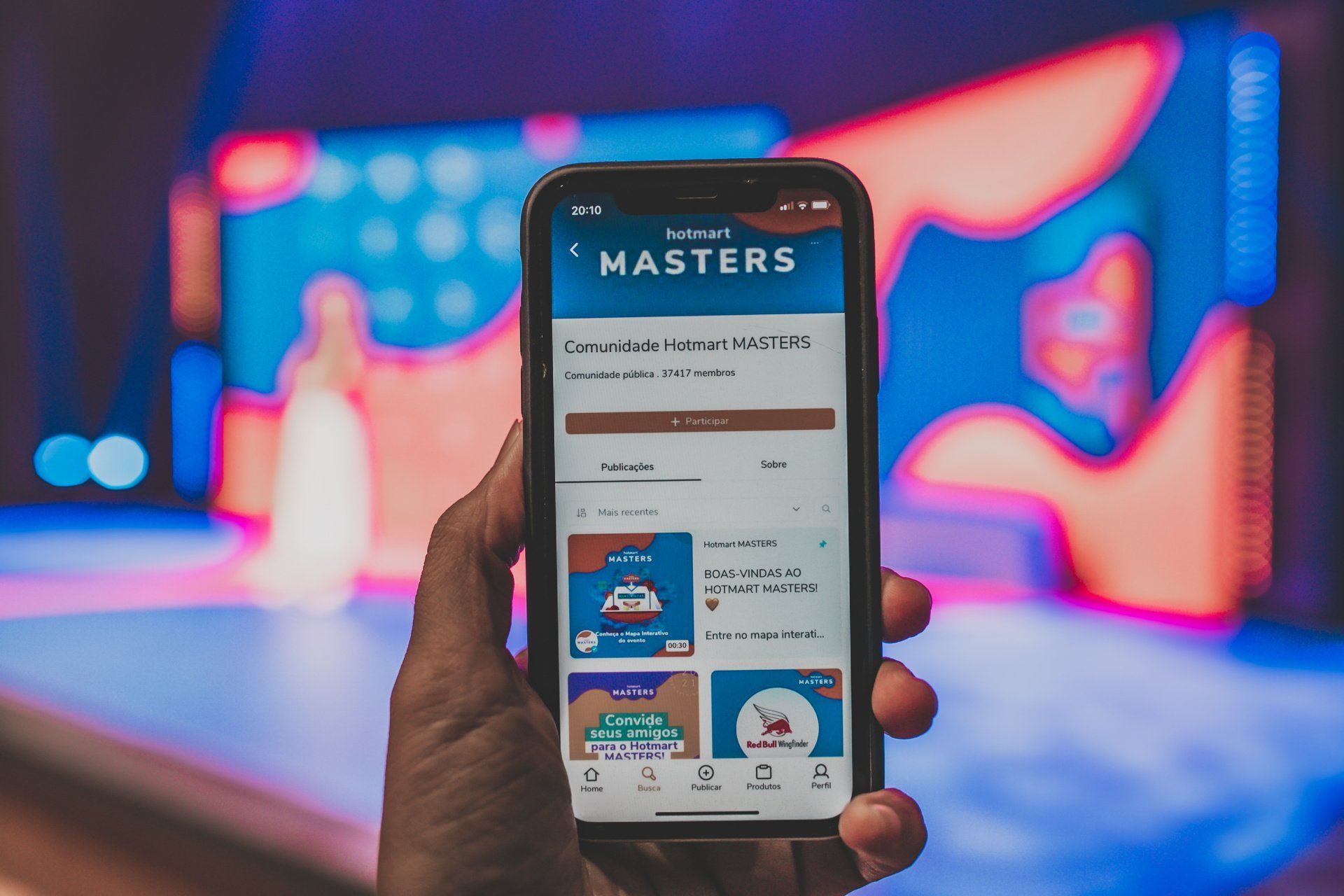 A person is holding a cell phone with the masters app on it.