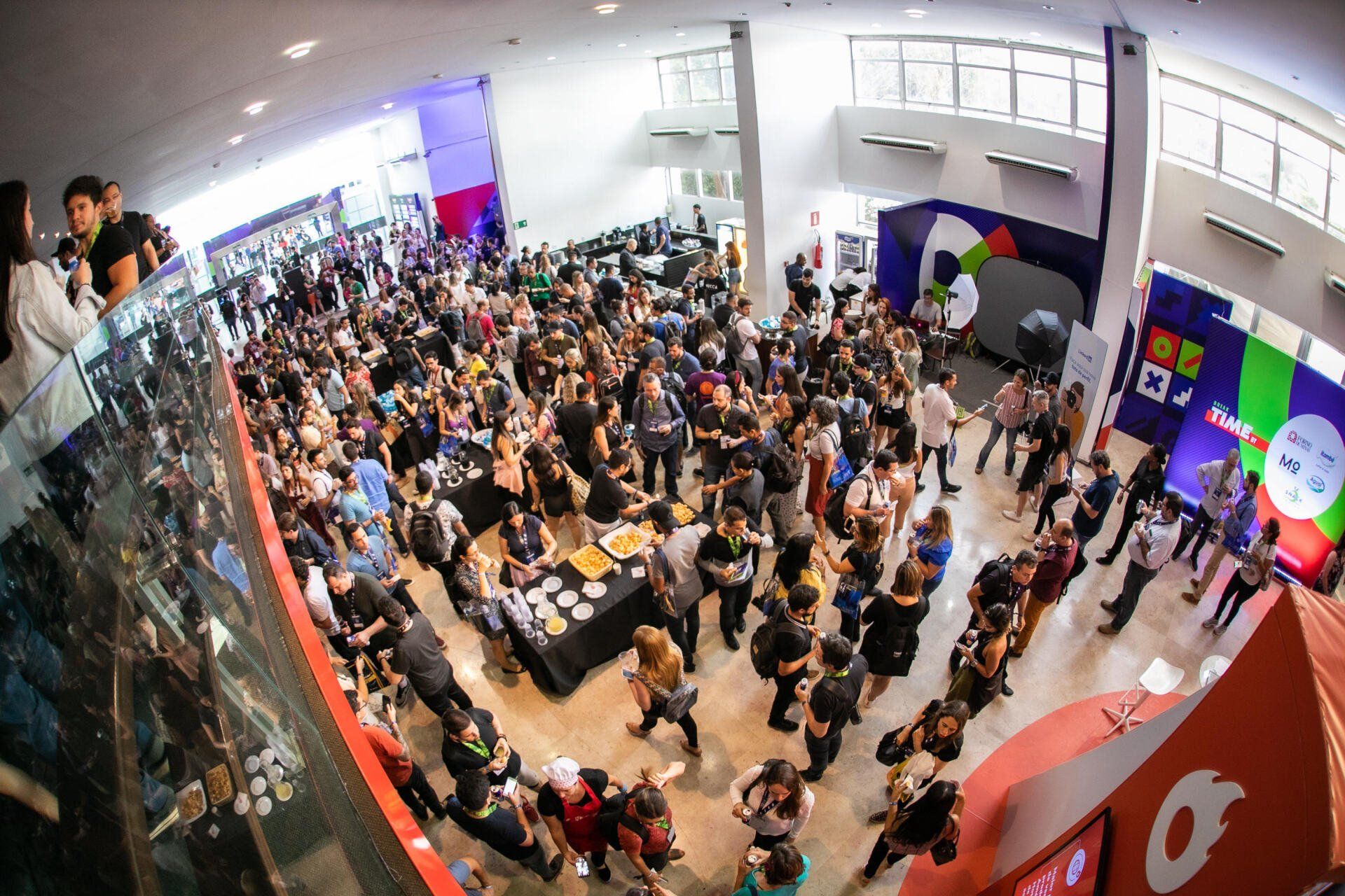 A large crowd of people are gathered in a large room.