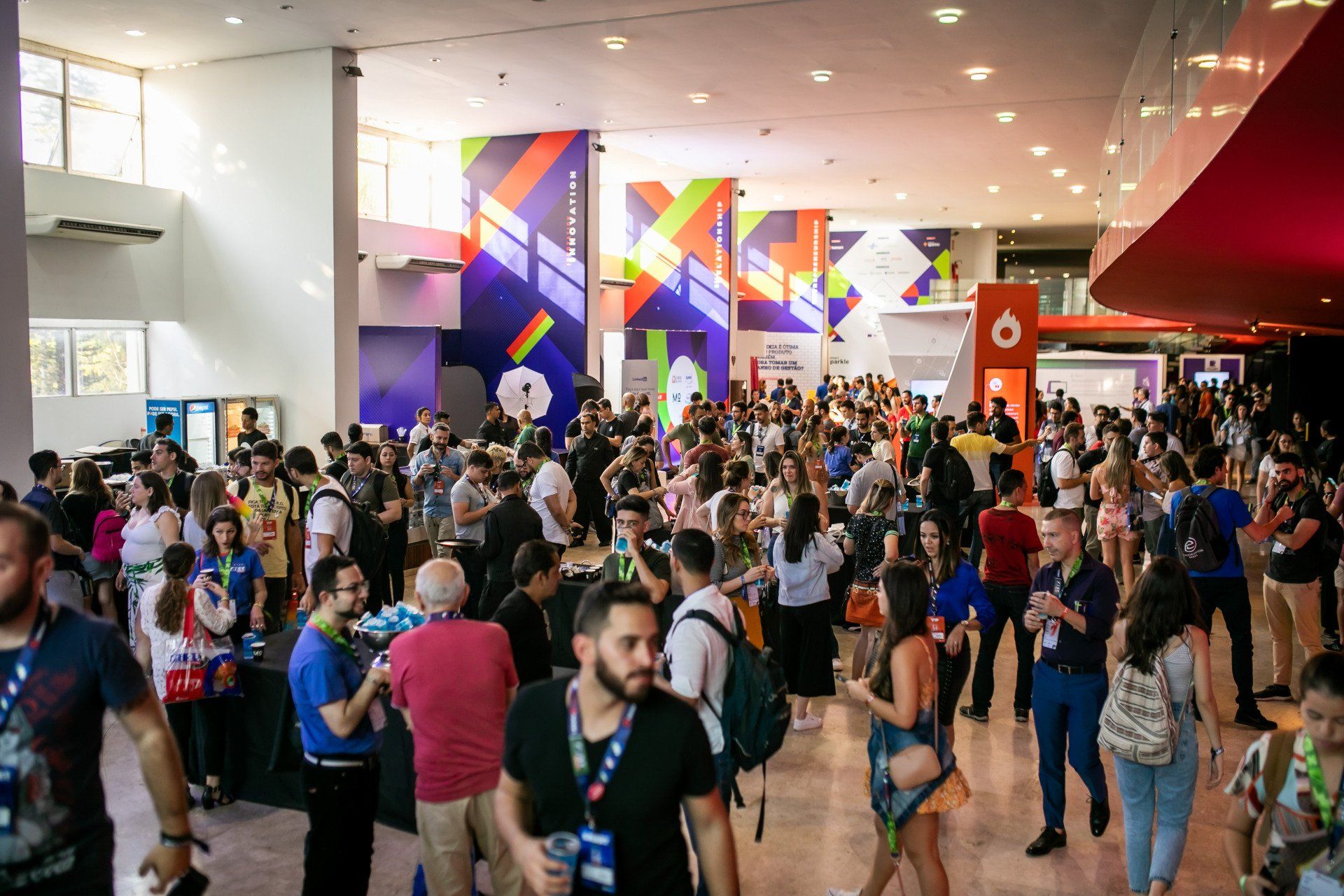 A large group of people are standing in a large room.