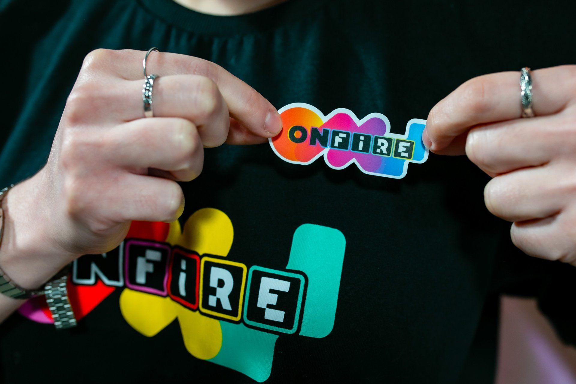 A person holding a sticker that says onfire