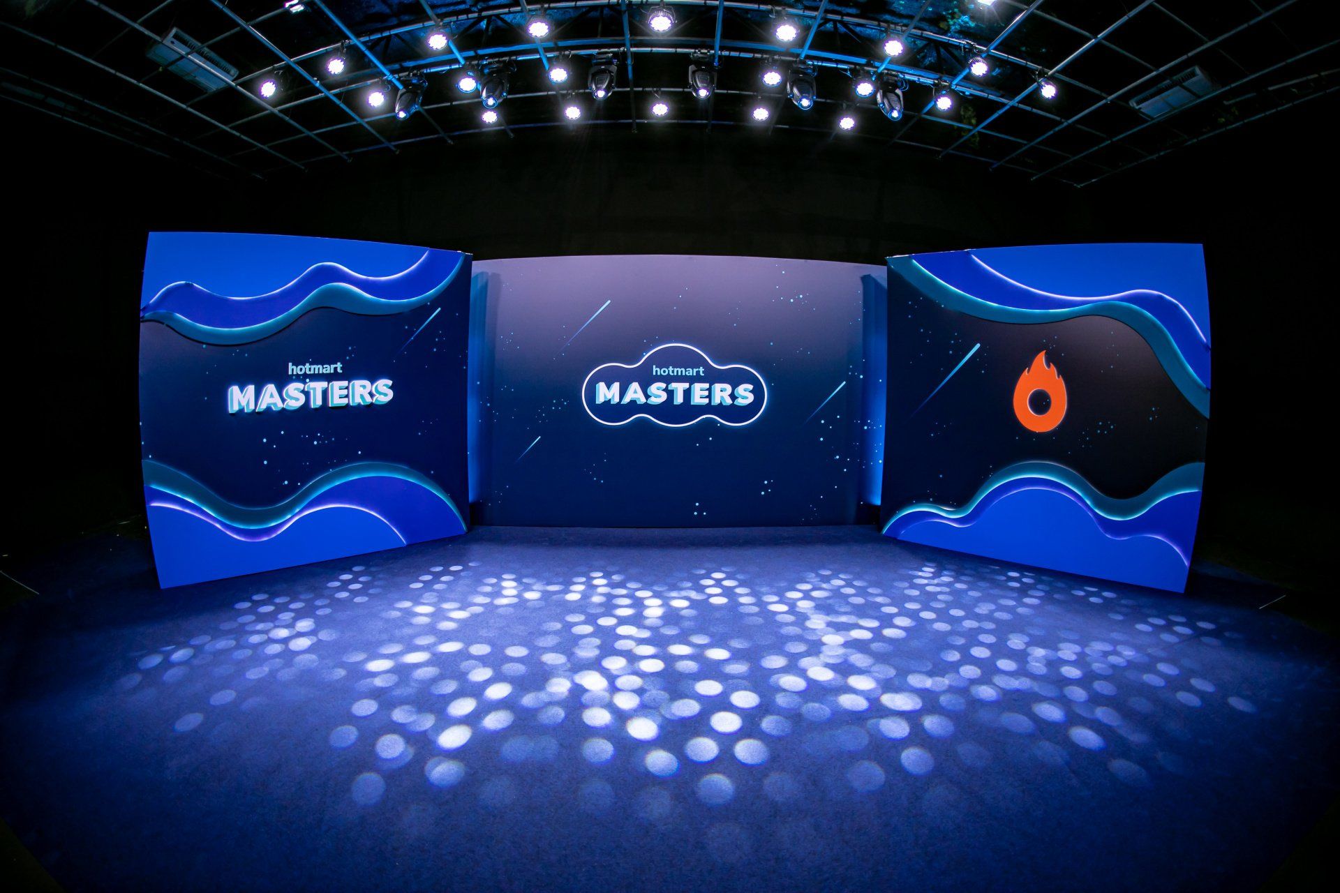 A stage with three screens that say masters on them