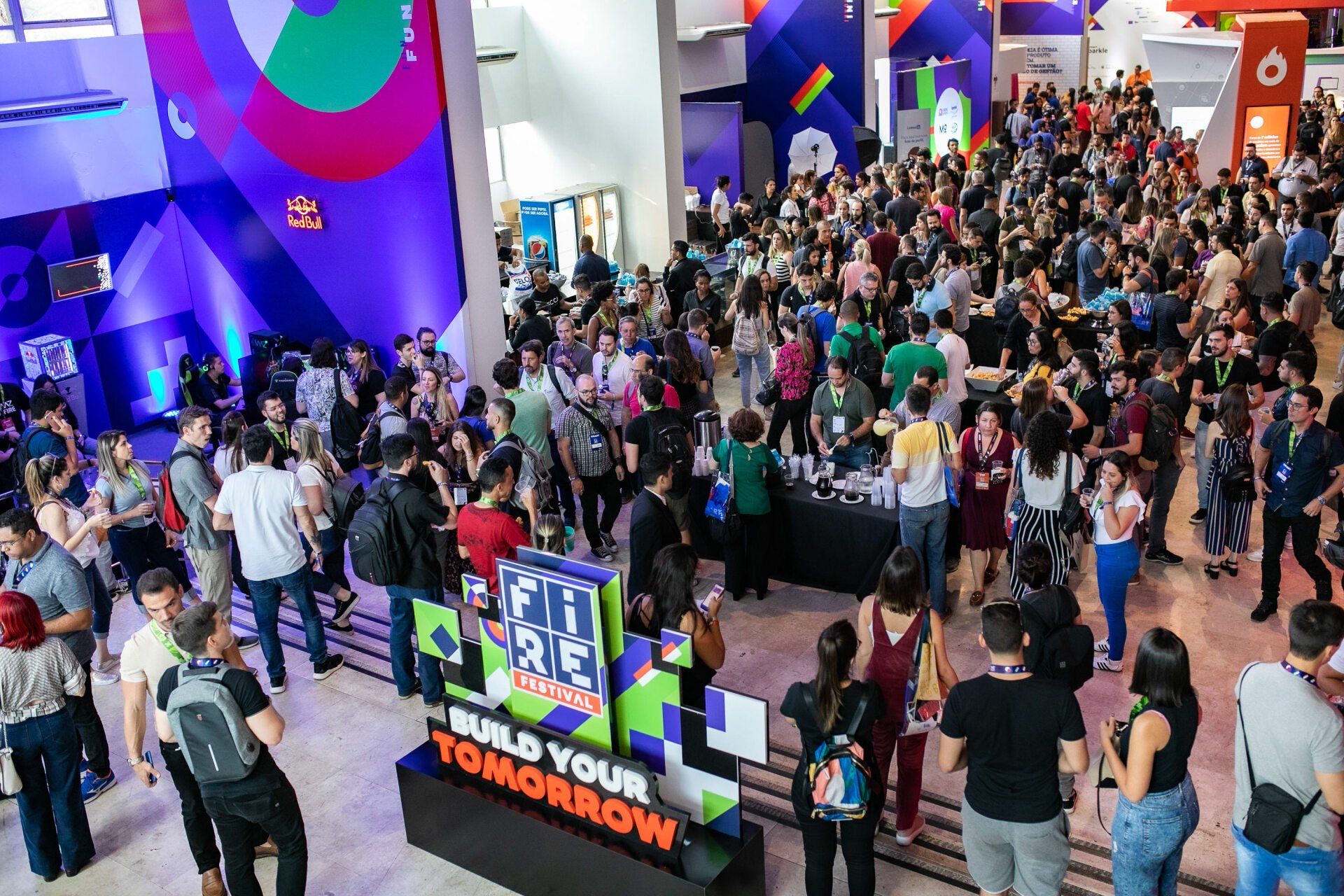 A large group of people are standing around a sign that says build your tomorrow.