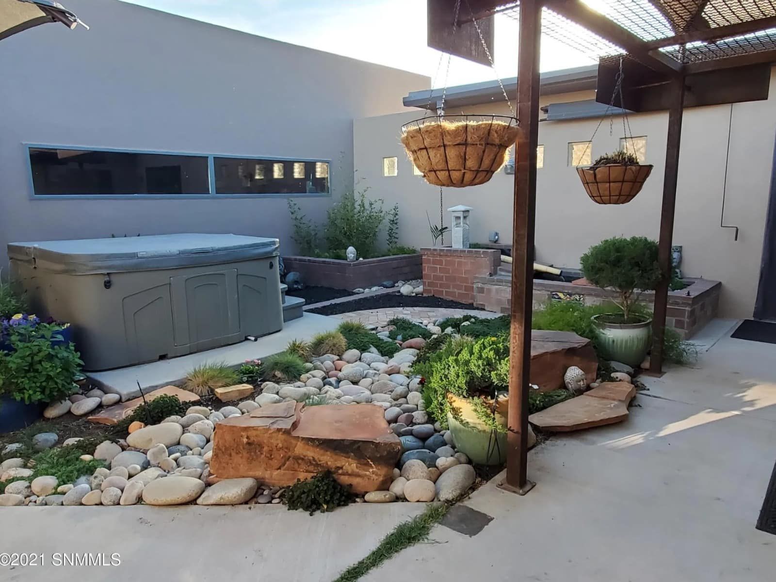 There is a hot tub in the backyard of a house.
