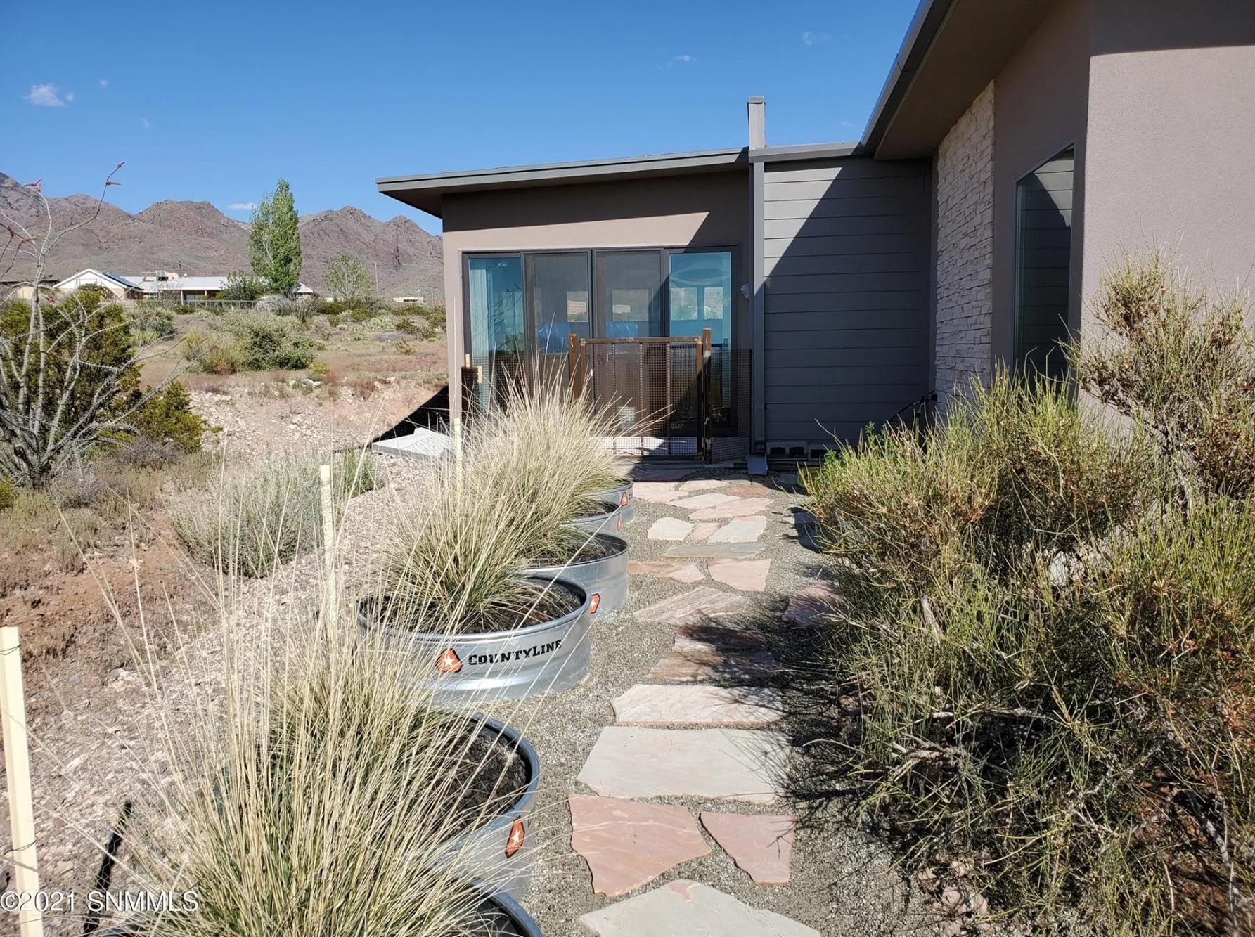 A walkway leading to a house in the desert
