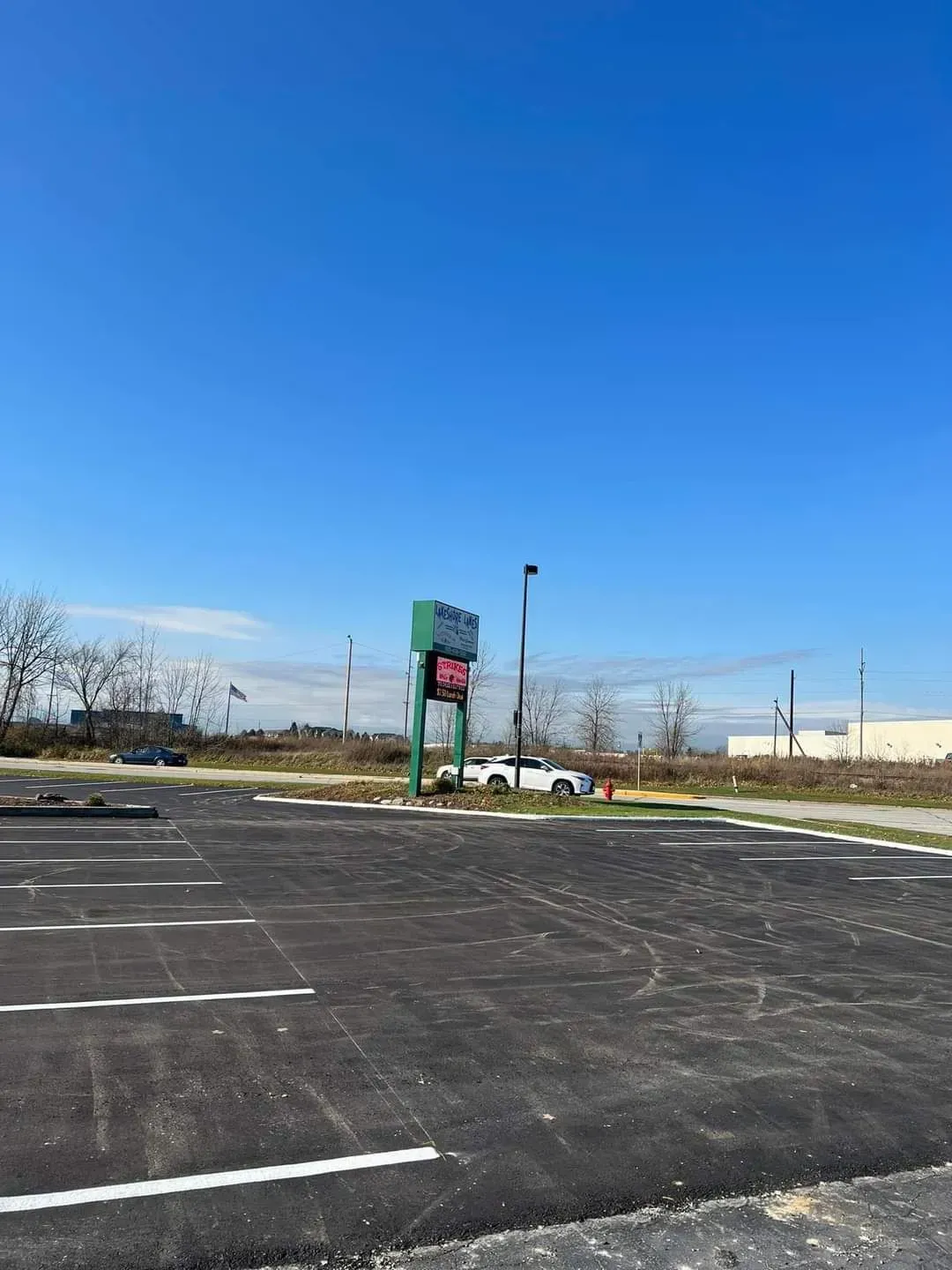 A parking lot with cars parked in it on a sunny day.