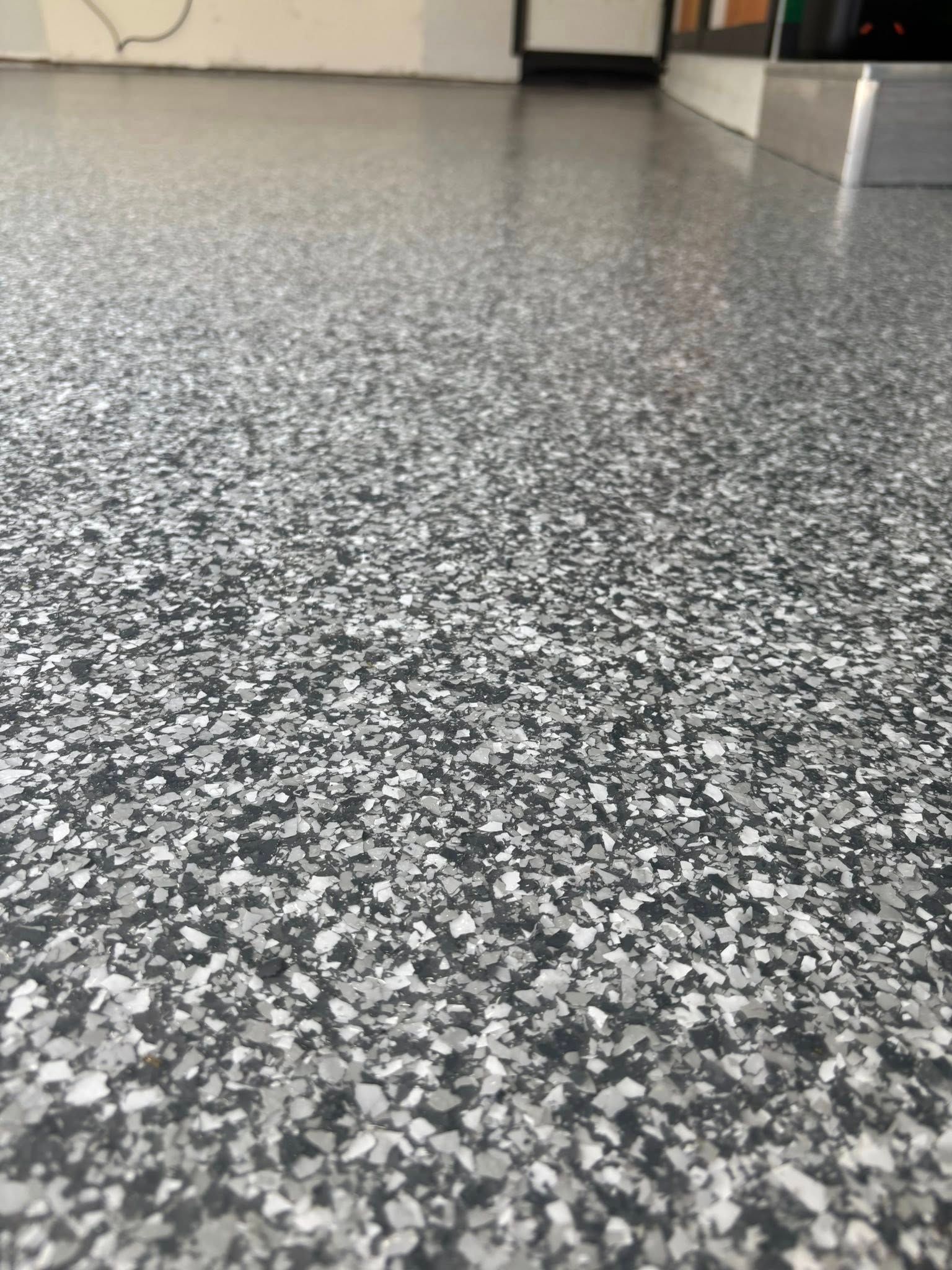 Gray and white speckled epoxy garage floor.