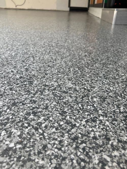 Gray and white speckled epoxy garage floor.