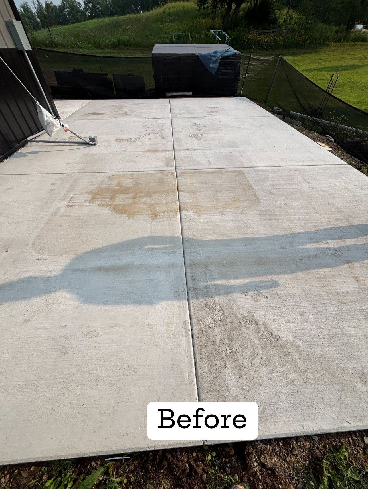 Concrete patio before cleaning, showing stains and discoloration.