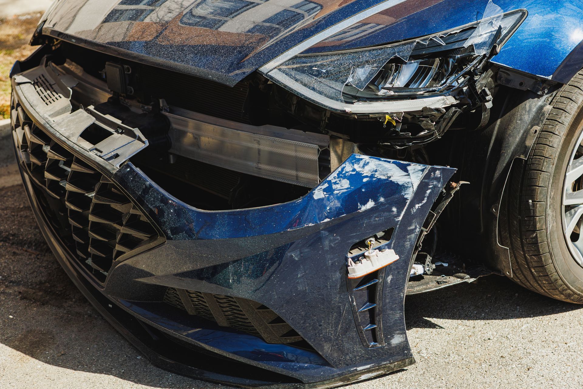Front-end vehicle damage awaiting collision repair after an accident