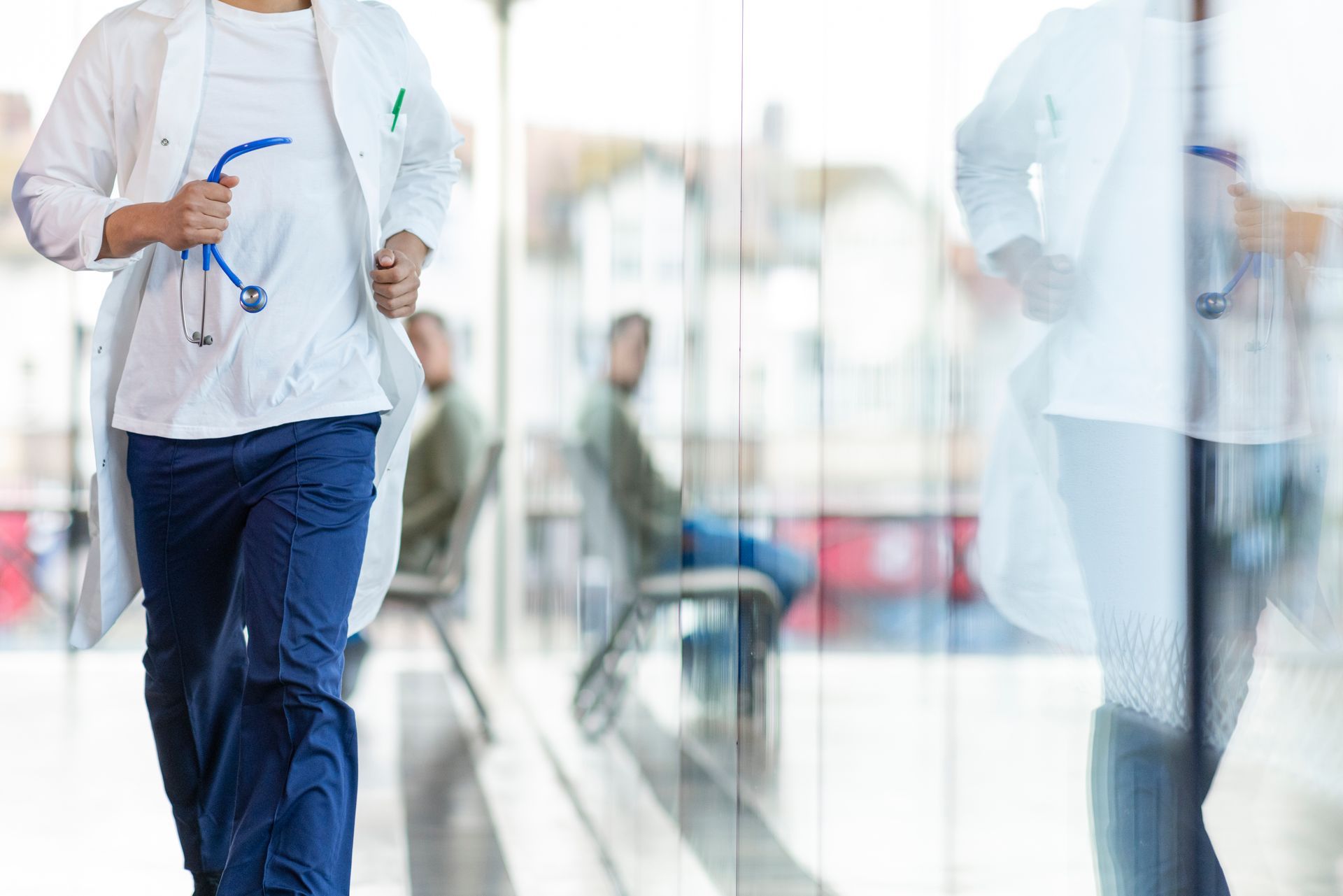 Medical professional walking down hospital hall