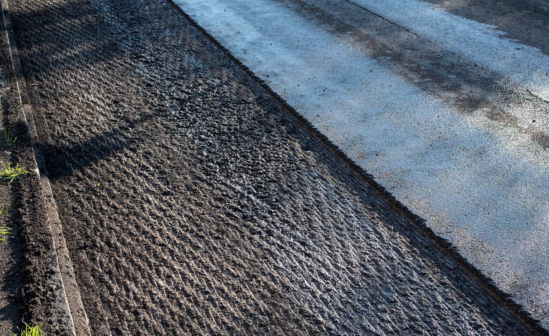 A close up of a road with a lot of dirt on it.