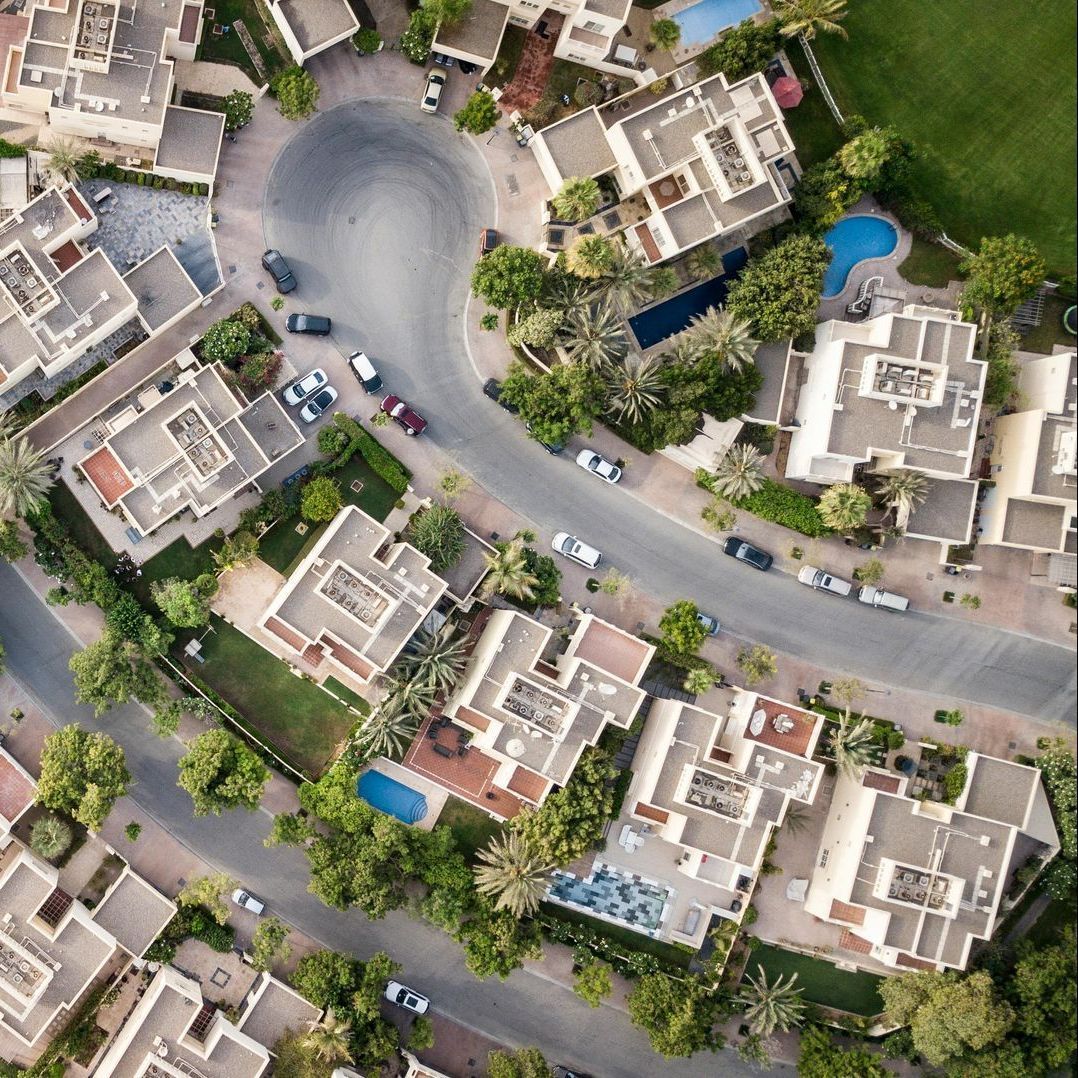 an aerial view of a residential area with lots of houses and trees