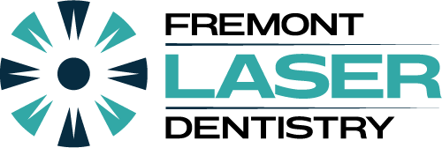 Logo of Fremont Laser Dentistry. Features teal and navy circular design with the name in black and teal.