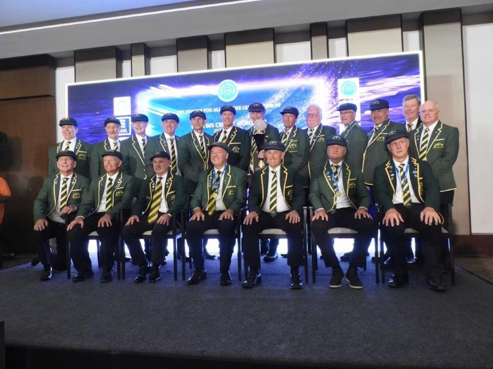 Group of men in matching green jackets, hats, and ties, posing