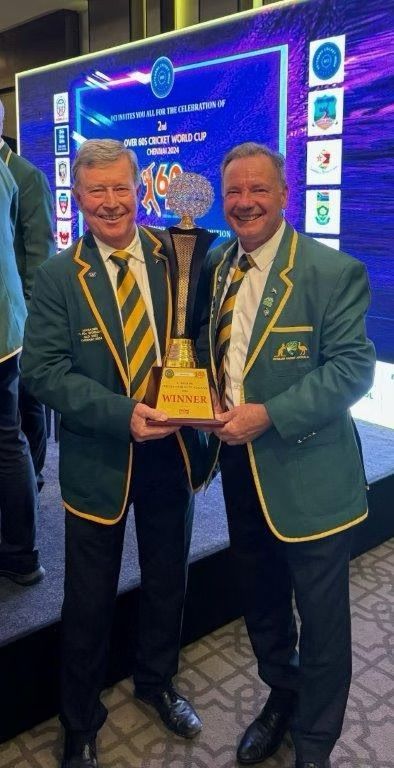 Two men holding a trophy, celebrating at an awards ceremony