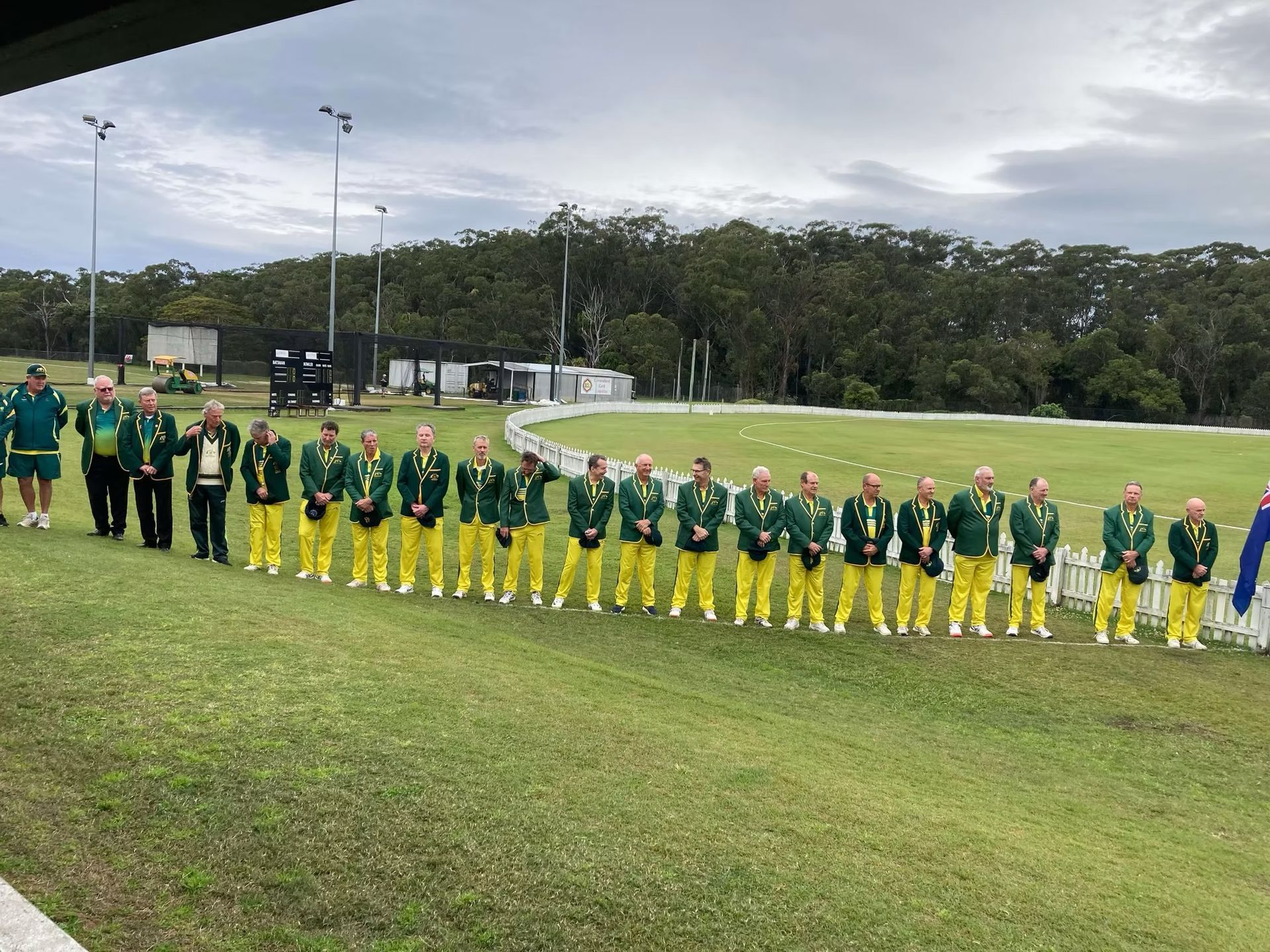 World Cup 2023 A line of people in green and gold uniforms stand on a grass field