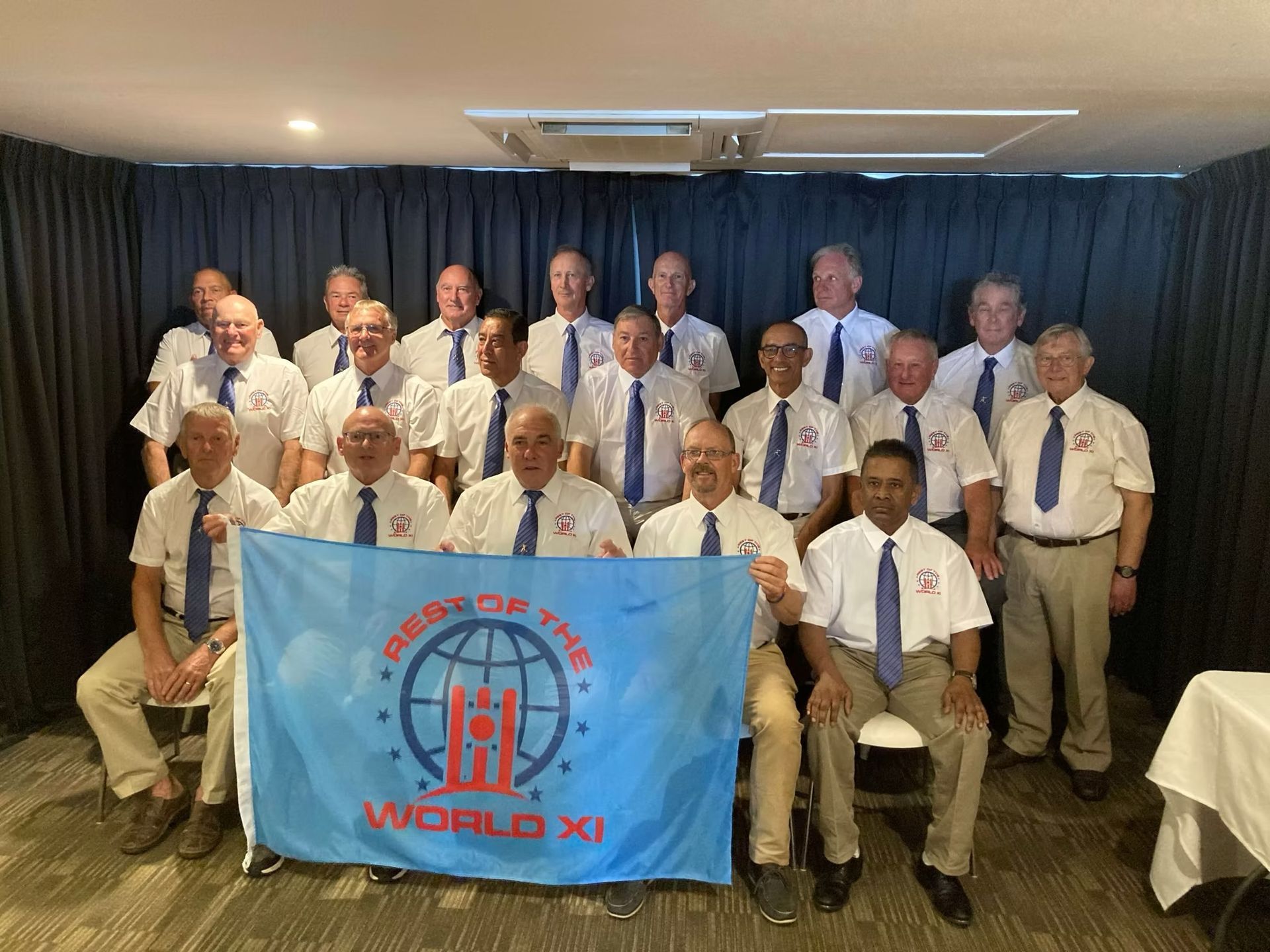 World Cup 2023 Group of men in white shirts and ties holding a banner