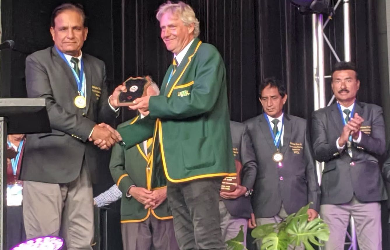 World Cup 2023 Two men shaking hands on stage, while receiving a trophy