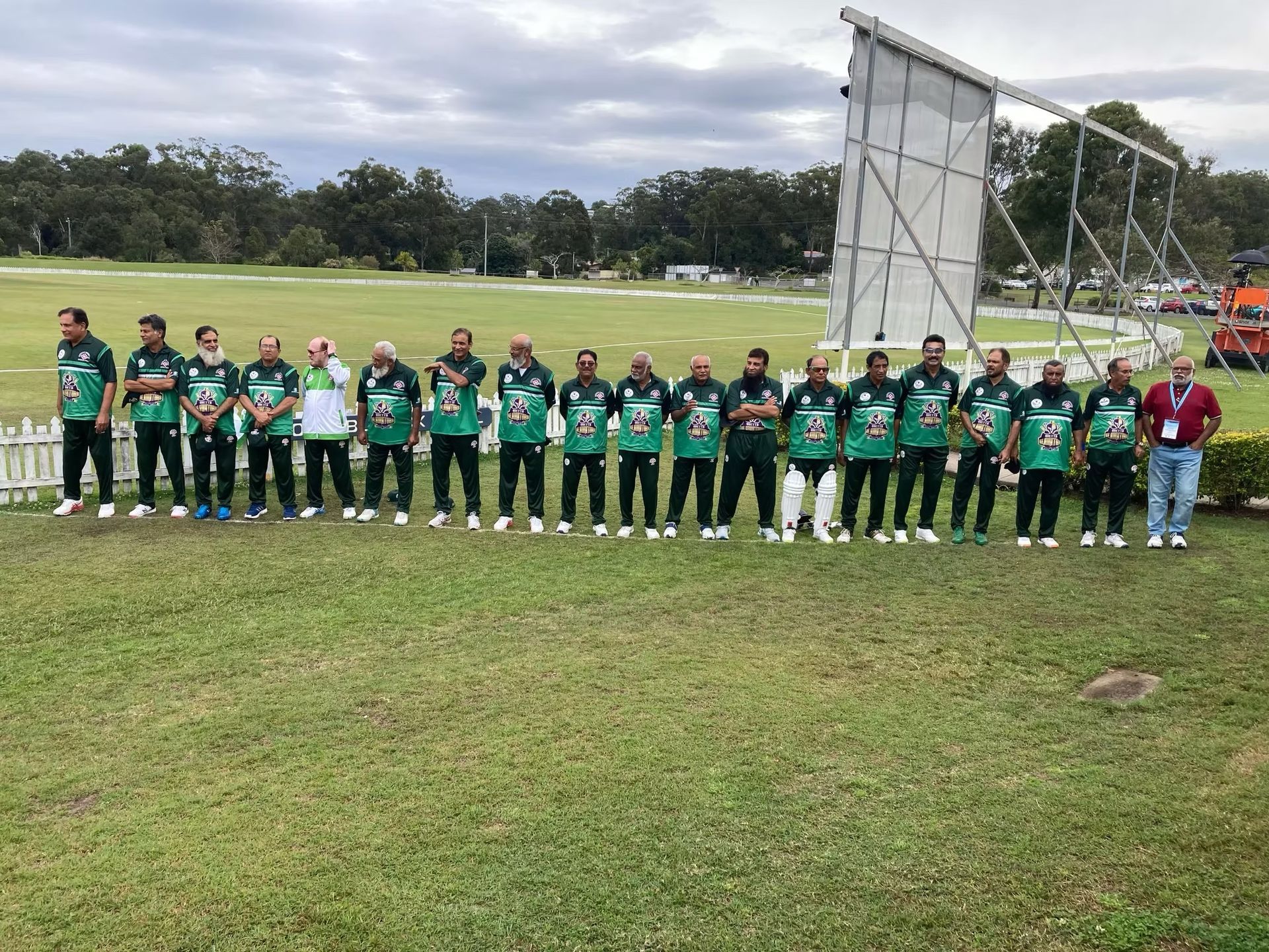 World Cup 2023 Cricket team in green uniforms stands on a grassy field