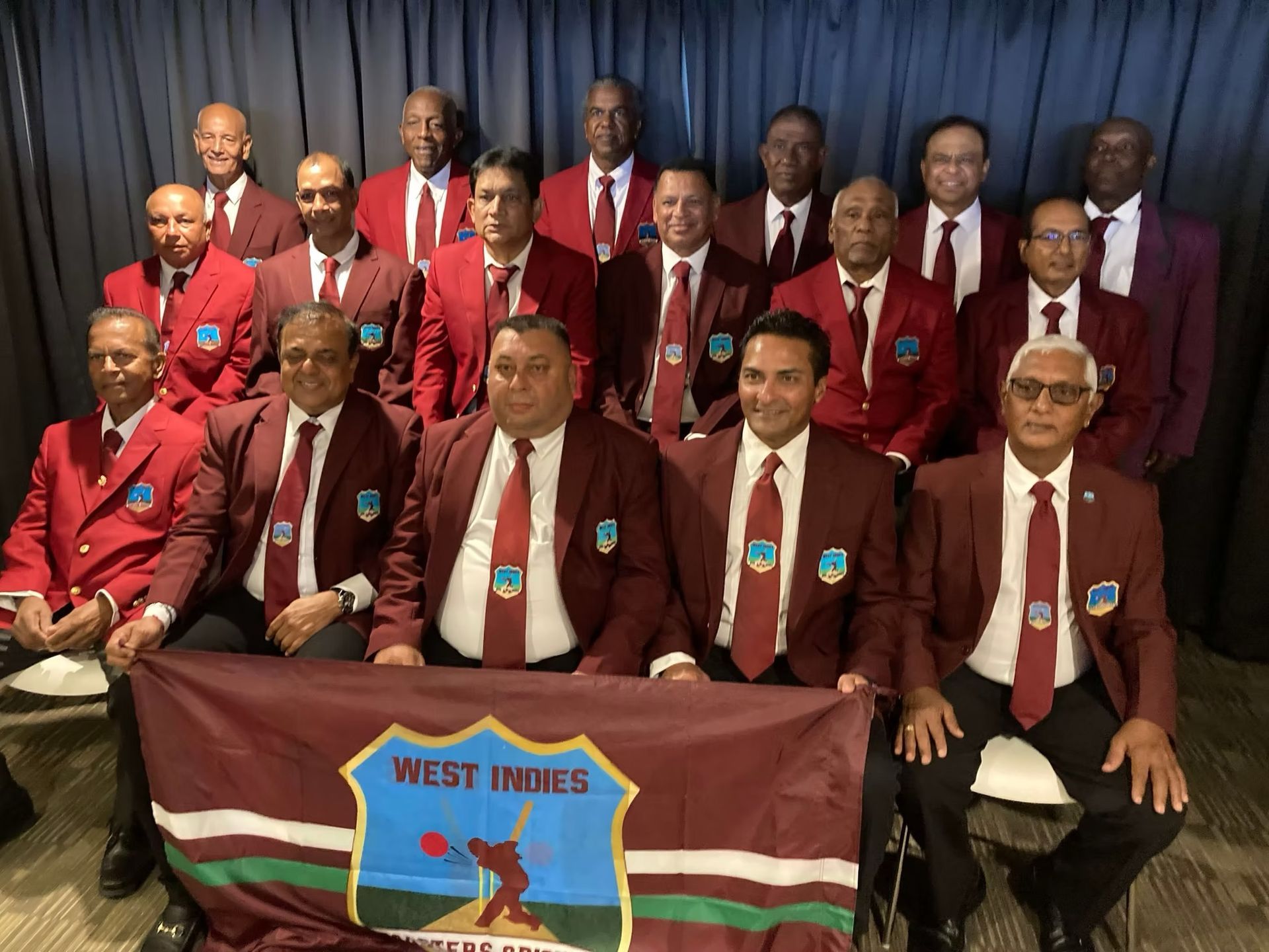 World Cup 2023 A cricket team holding a West Indies cricket banner.