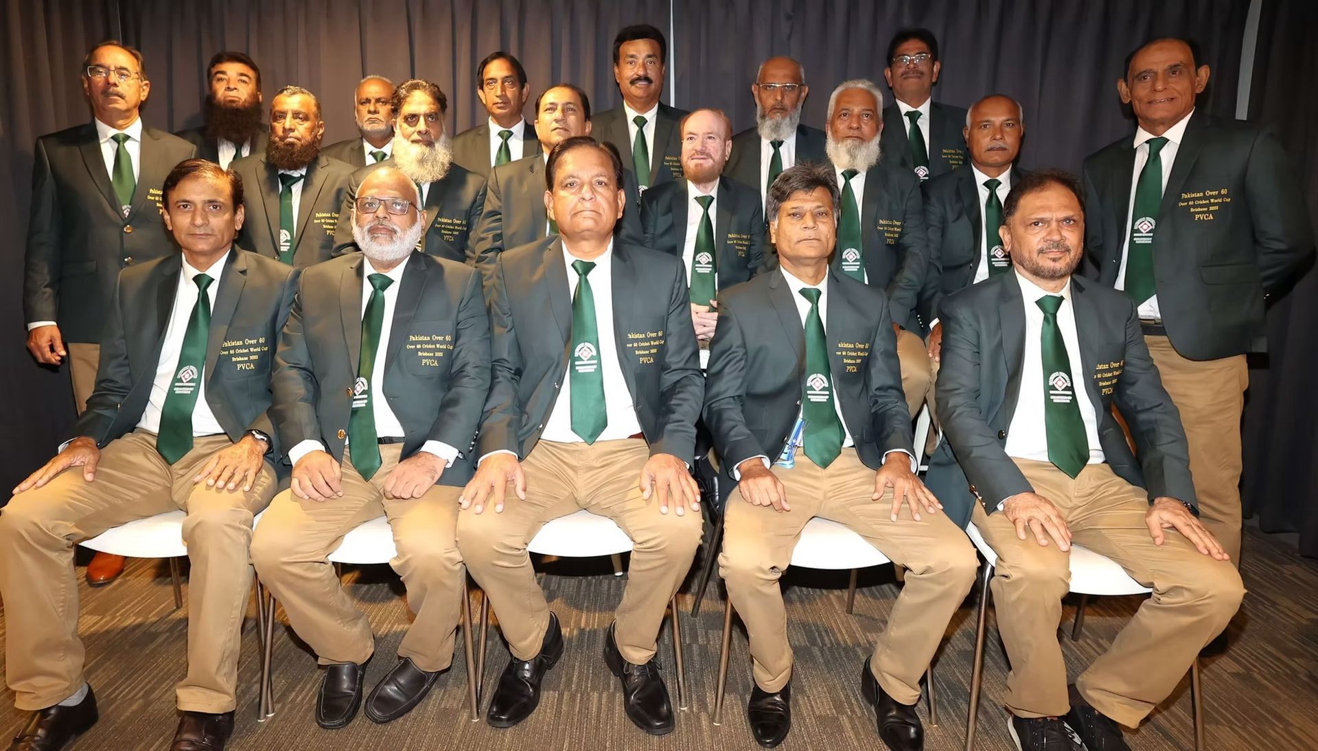 World Cup 2023 A cricket team in matching green jackets, posing indoors