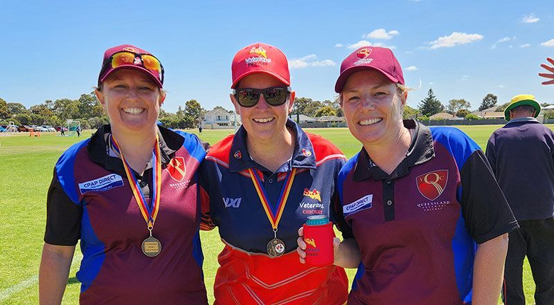 Three players from Women's team in maroon and blue uniforms