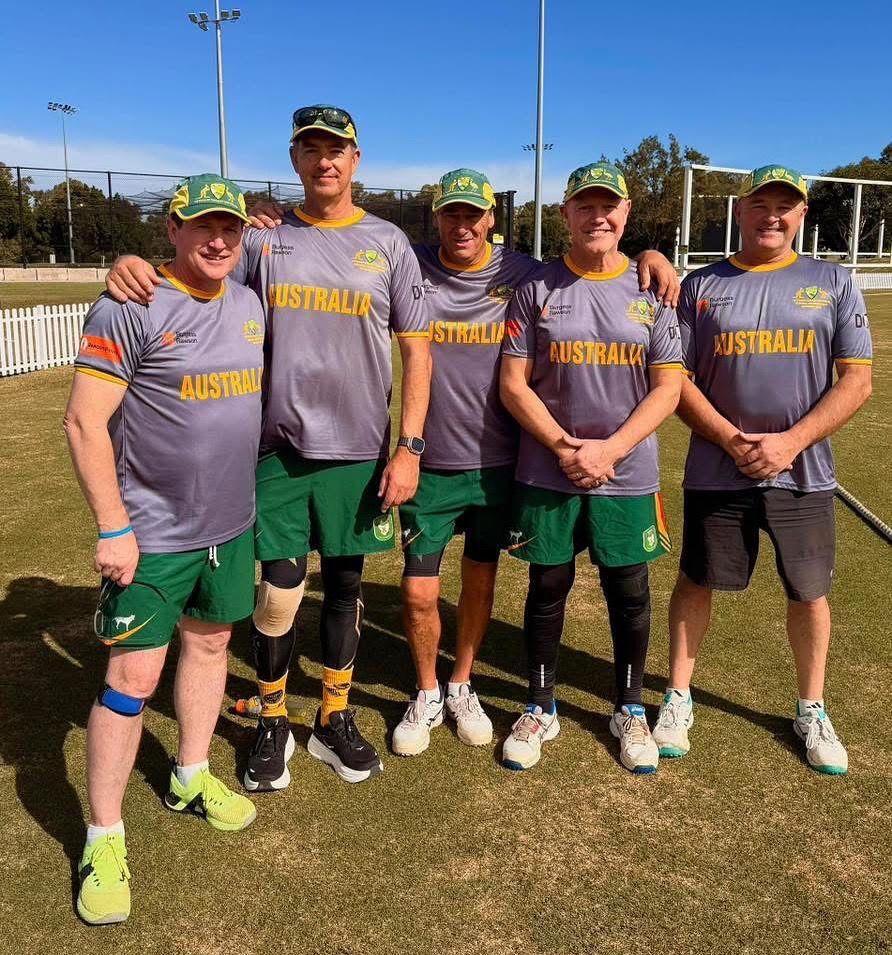 Five people in Australia team shirts, posing