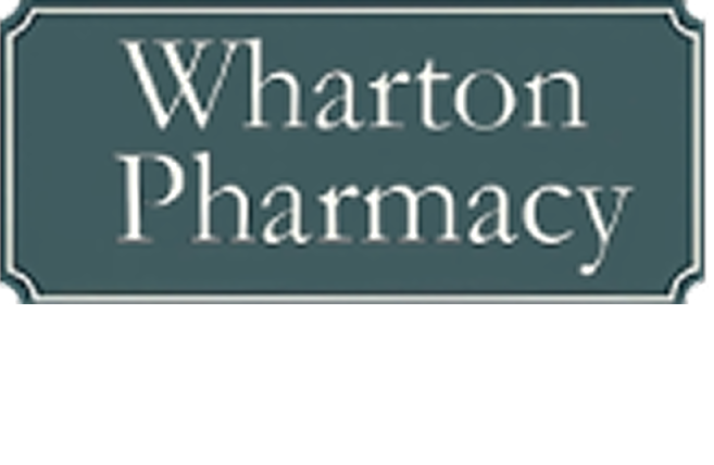 Sign for Wharton Pharmacy; white text on a teal background with a silver border.