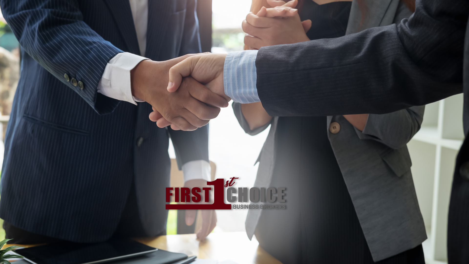 A group of people shaking hands in front of a sign that says first choice