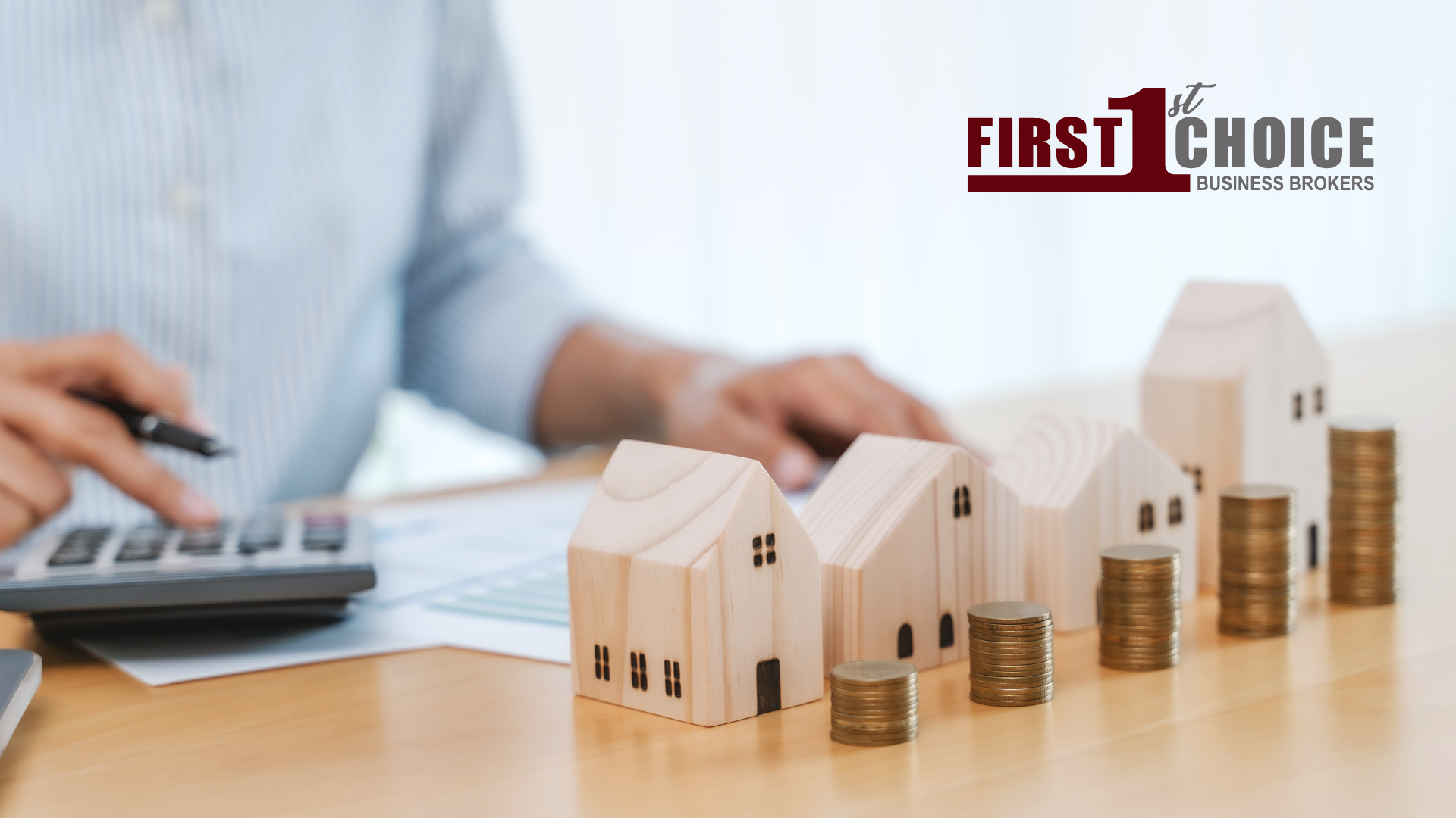 A person is using a calculator to calculate the cost of a house.